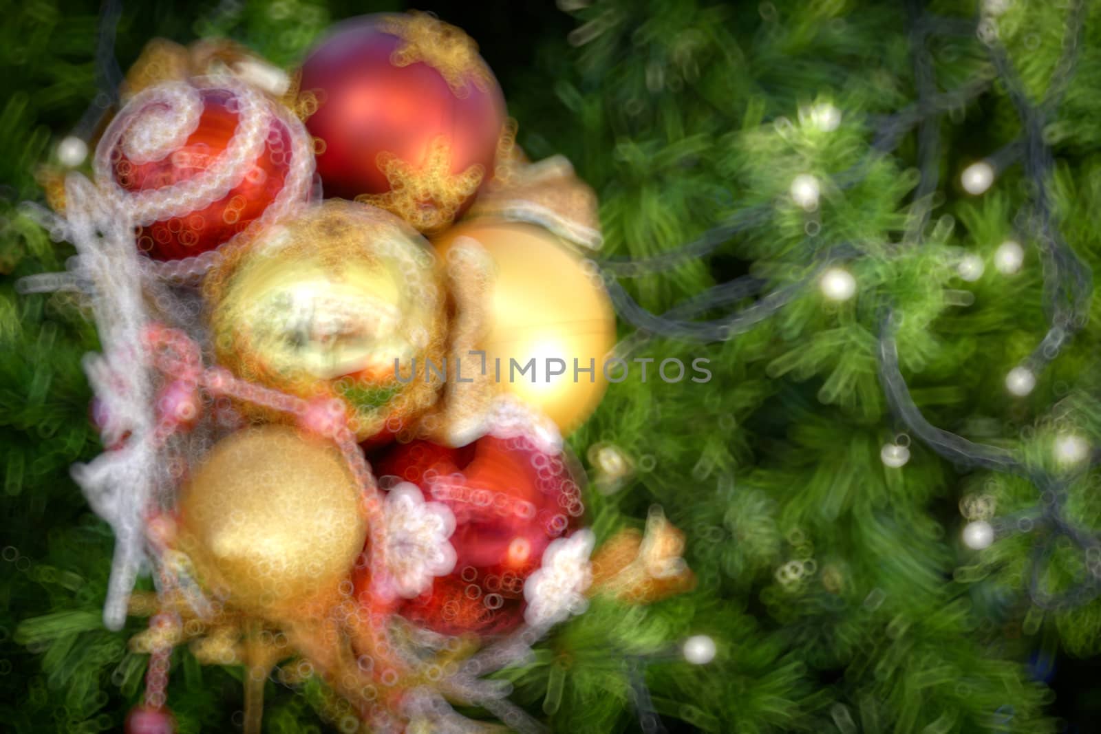 Gold Christmas background of de-focused lights with decorated tr by teerawit