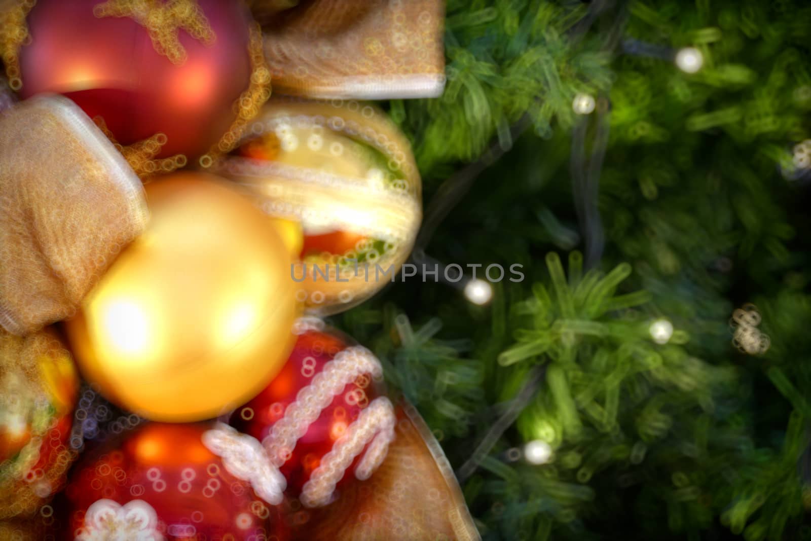 Gold Christmas background of de-focused lights with decorated tr by teerawit