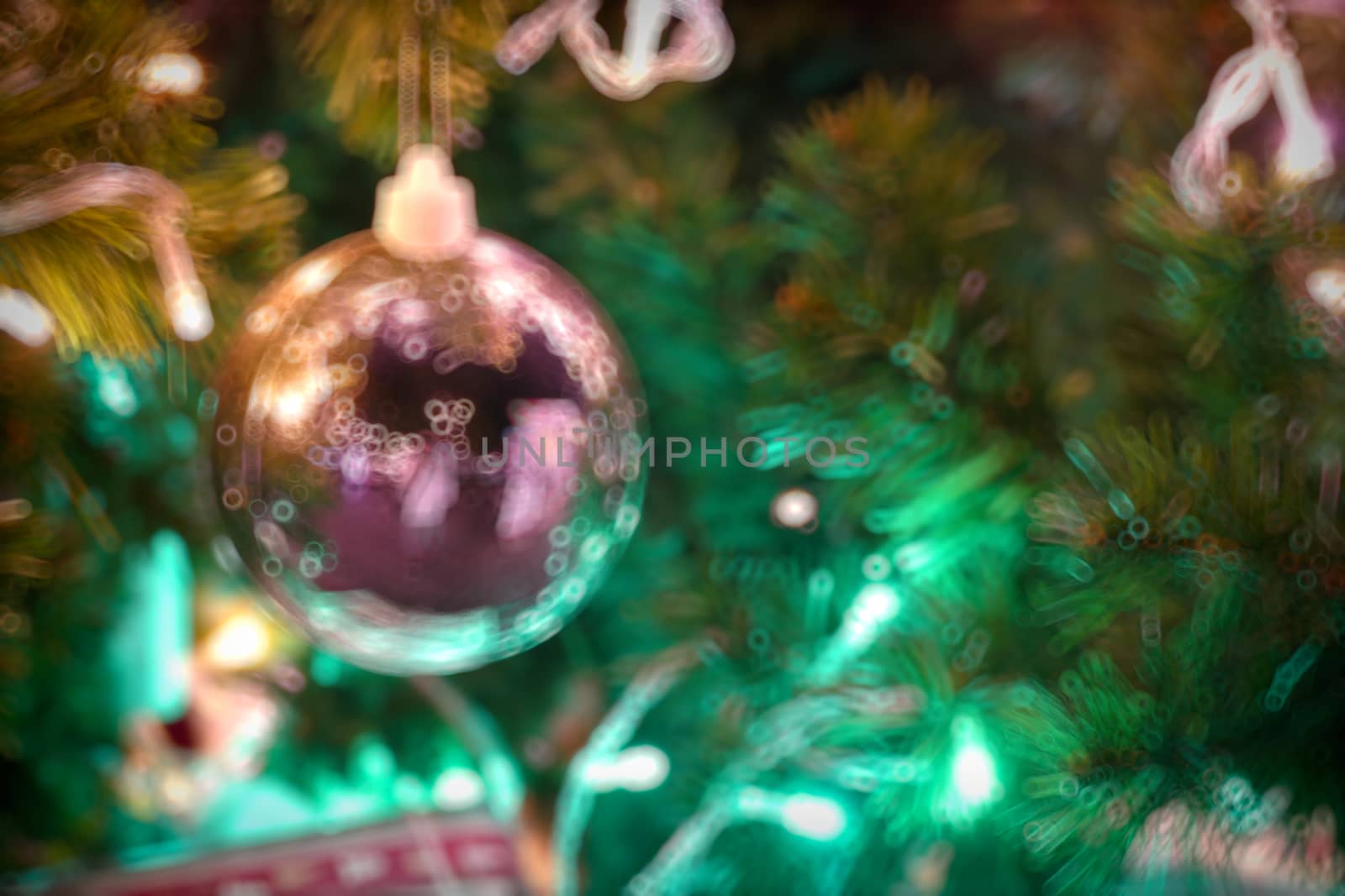 Gold Christmas background of de-focused lights with decorated tr by teerawit