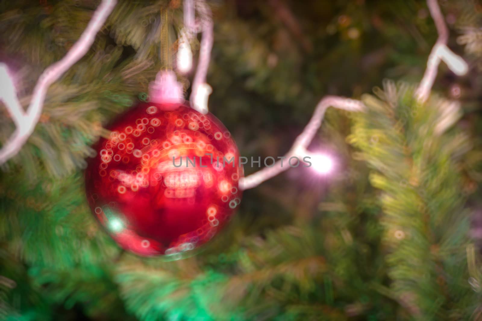 Gold Christmas background of de-focused lights with decorated tr by teerawit