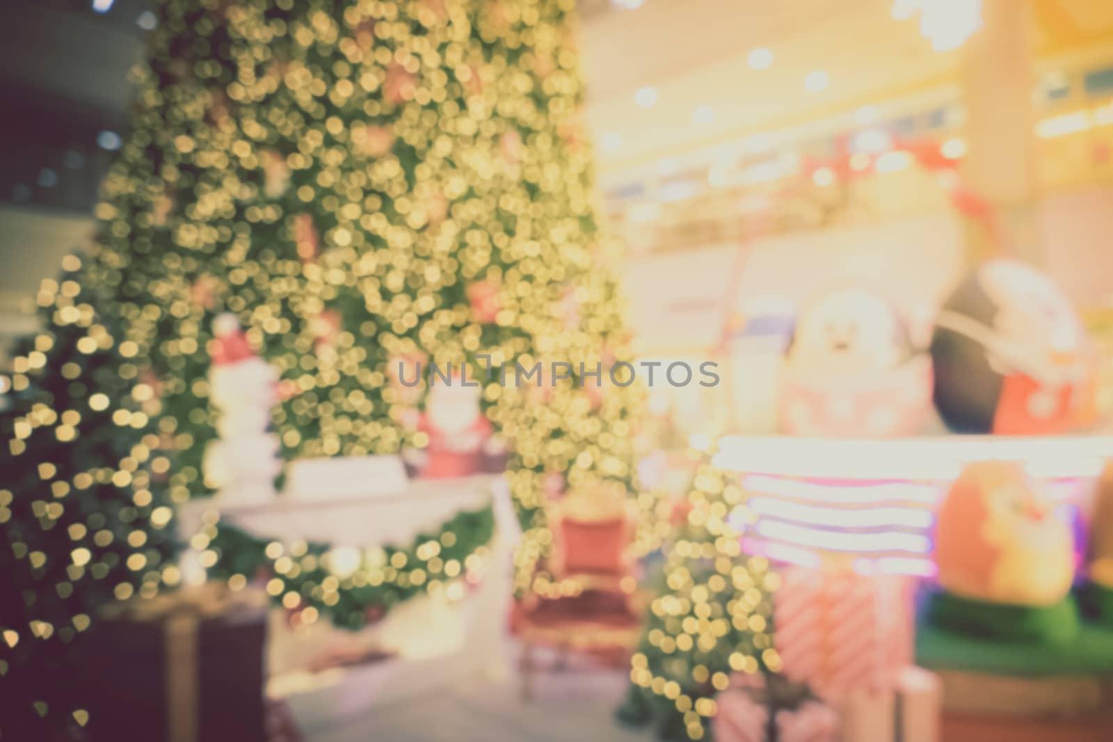 Gold Christmas background of de-focused lights with decorated tr by teerawit