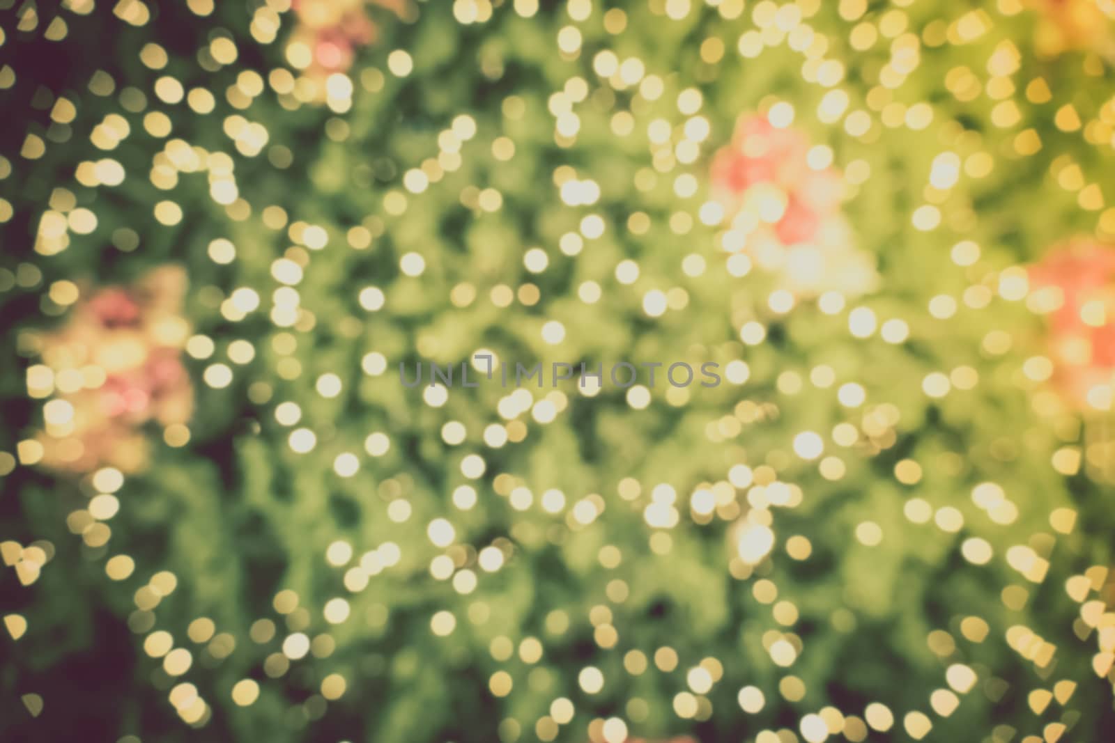 Gold Christmas background of de-focused lights with decorated tr by teerawit