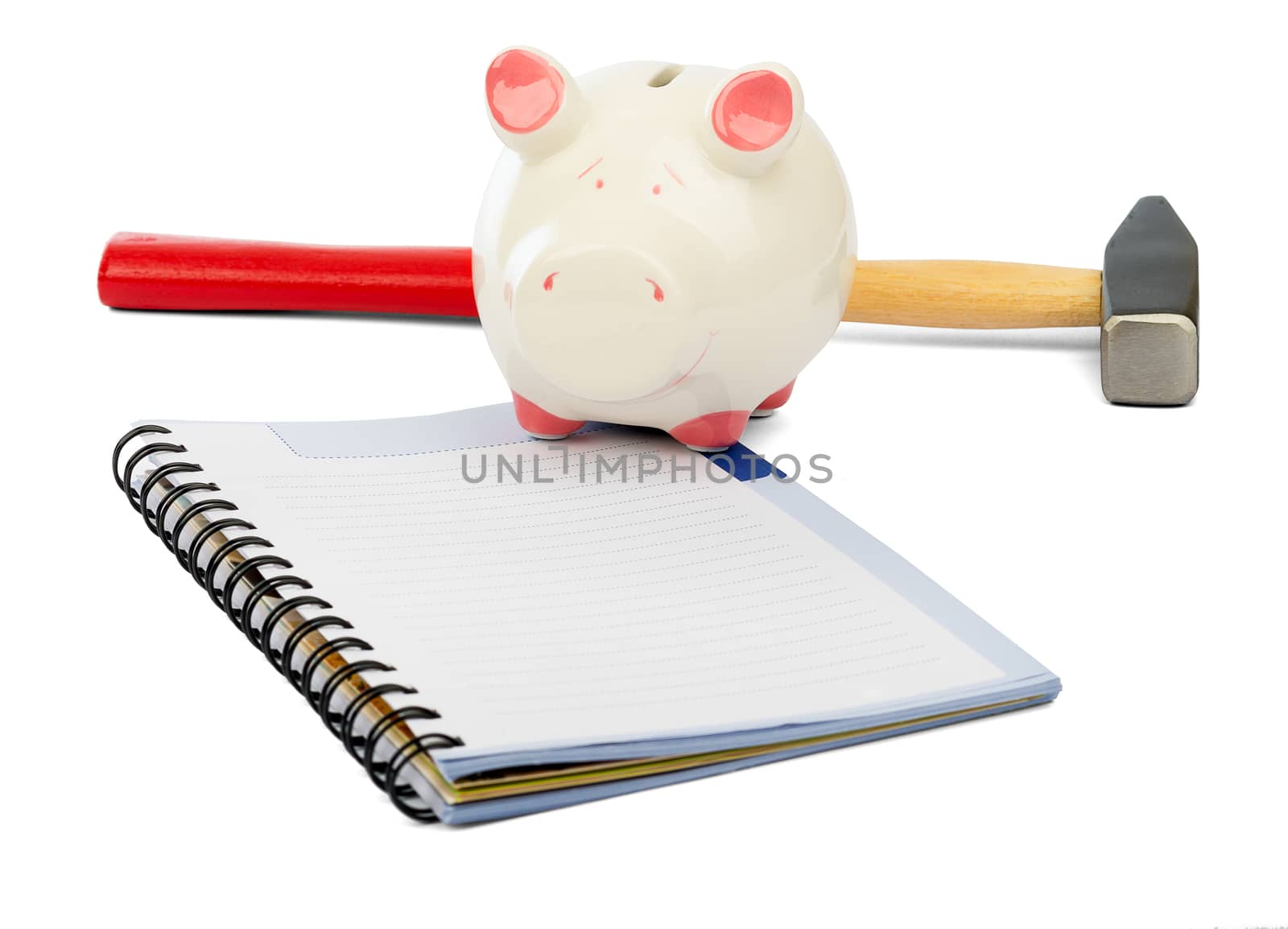 Piggy bank with hammer and pad on isolated white background