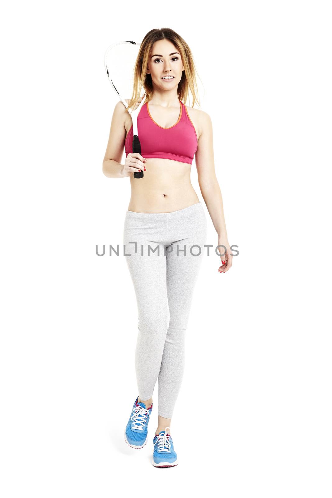 Studio shot of young attractive woman goes home from a training. 