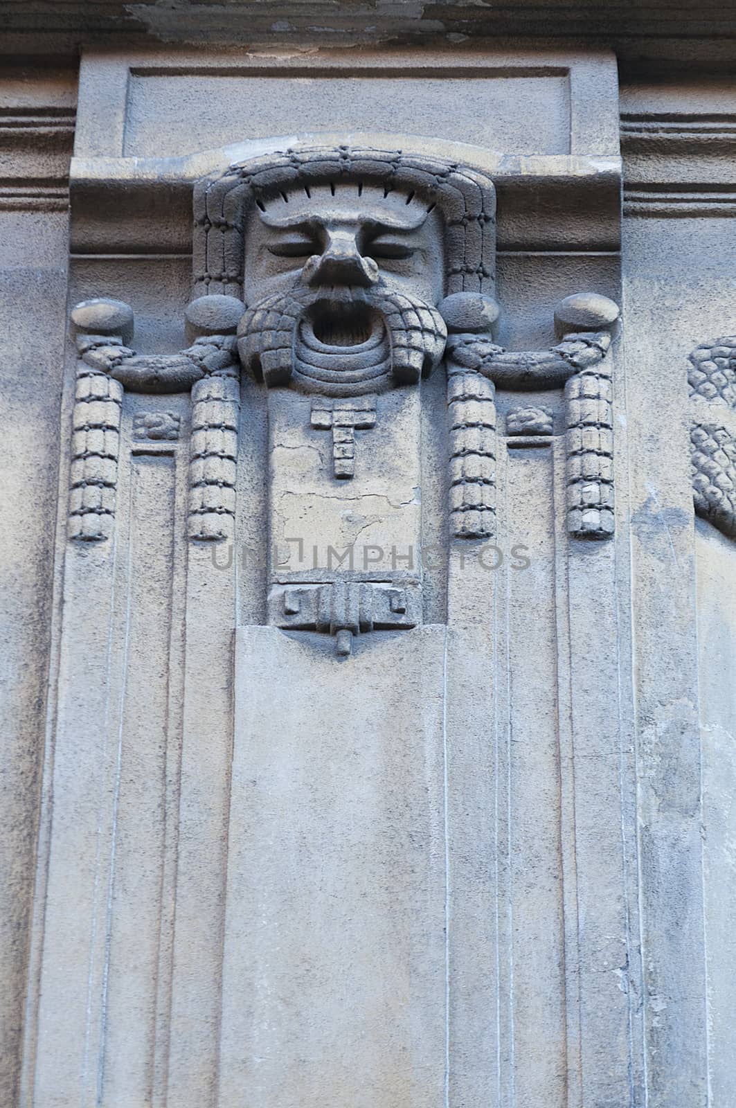 Man face on the wall. Architecture detail. Stone sculpture. Parged with plaster