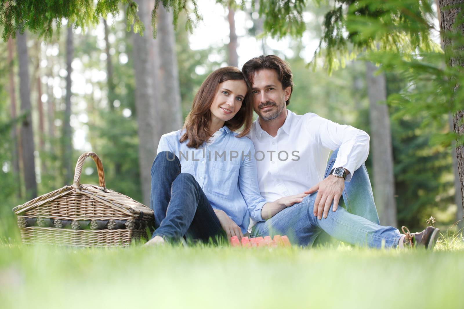 Young beautiful couple on picnic in summer park