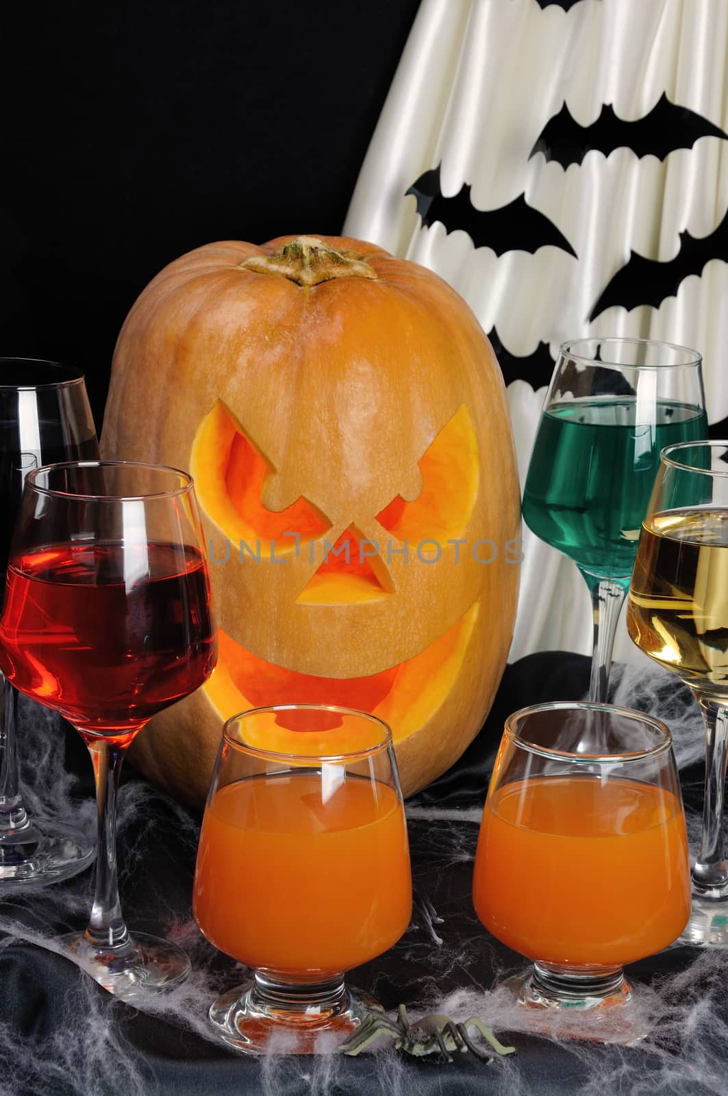 Glasses with different drinks on the table in honor of Halloween