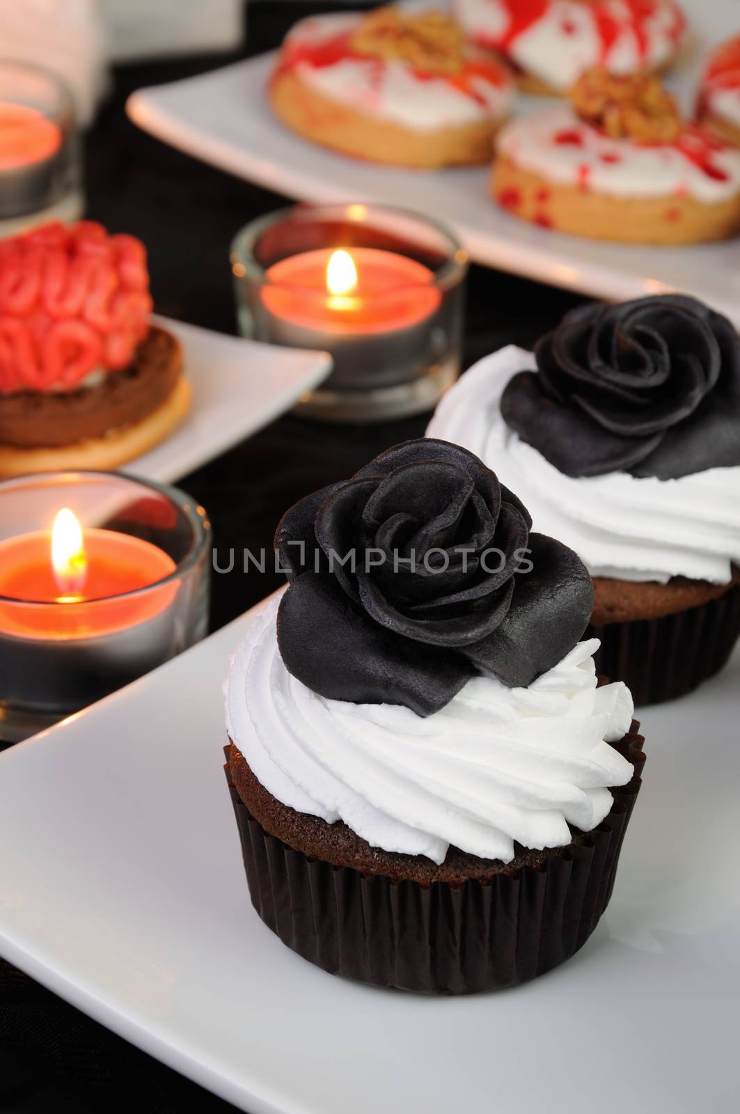 Chocolate muffin with cream decorated with black protein rose from marzipan