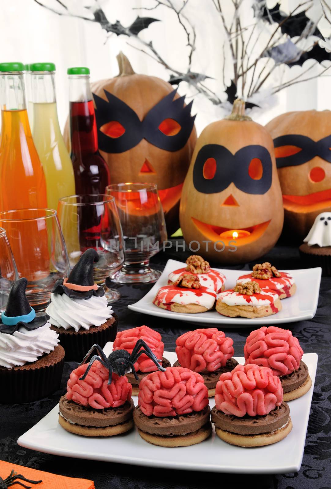 Cookies brains of marzipan on a table with a variety of sweets in honor of Halloween