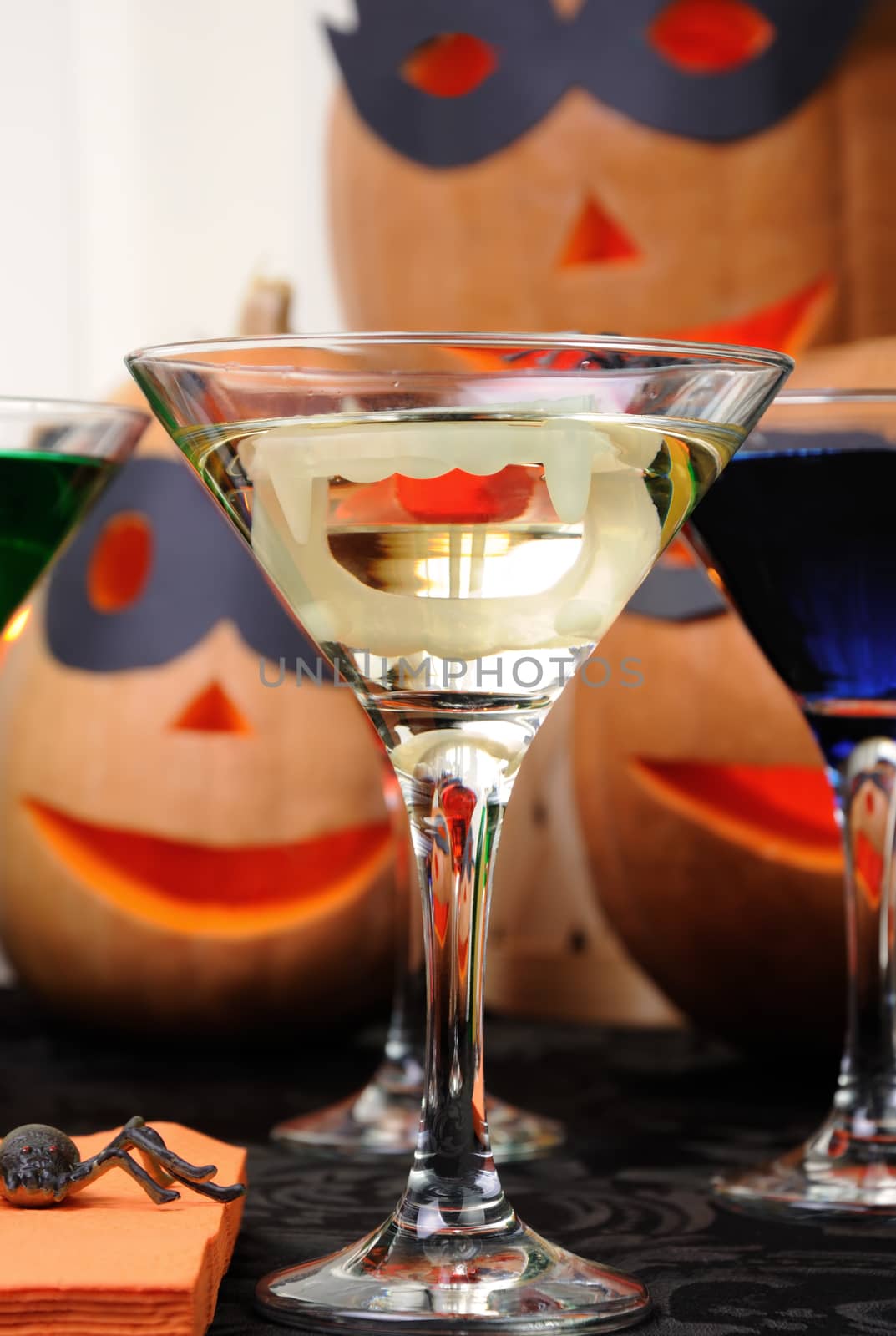 martini vampire  with jaws in a glass on the table in honor of Halloween