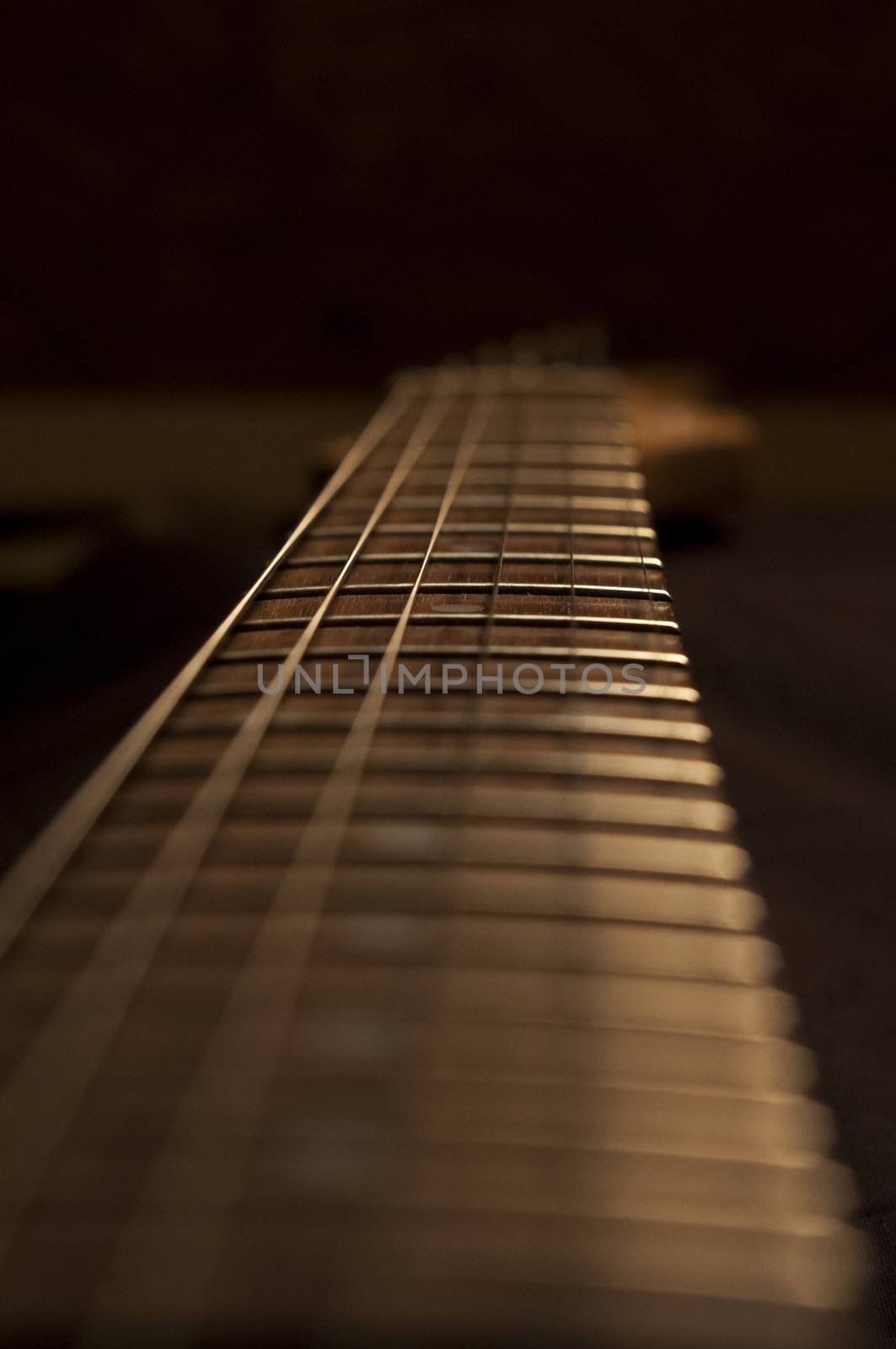 View of a guitar neck with tight depth of field and low angle