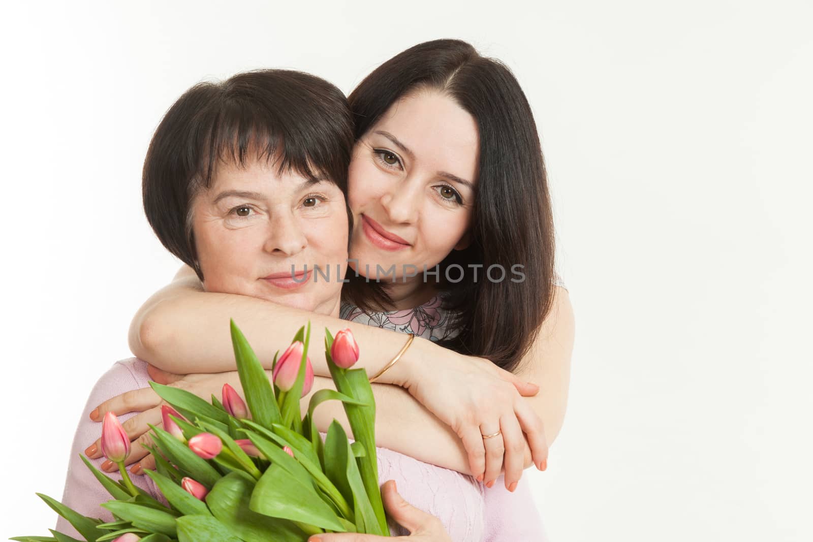 the woman presented a bouquet of flowers for mother and embraces her