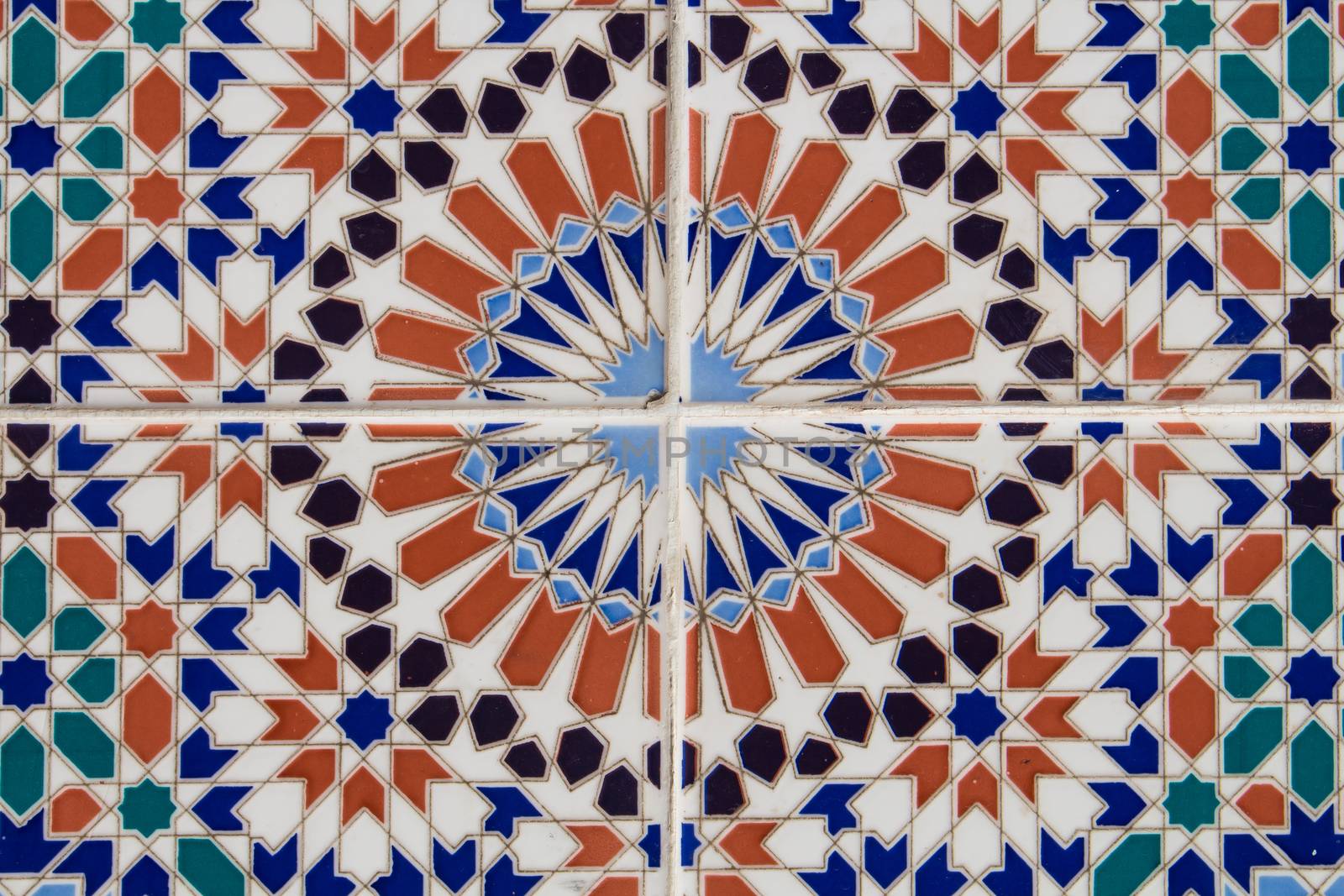 Ornamental geometric pattern on the colorful traditional tiles on the wall. Marrakesh, Morocco.