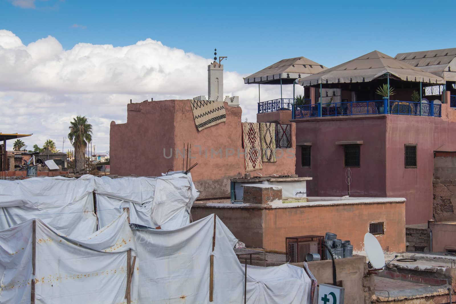 View from a roof on the old city - medina of Marrakesh. Small residential houses. Cloudy sky.