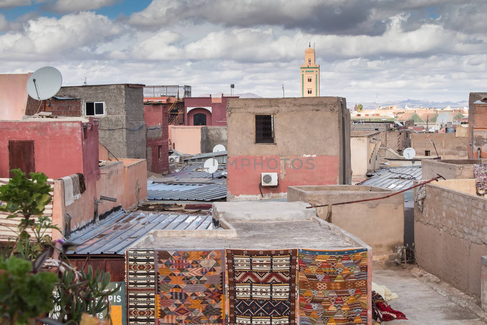 View from a roof on the old city - medina of Marrakesh. Small residential houses. Cloudy sky.