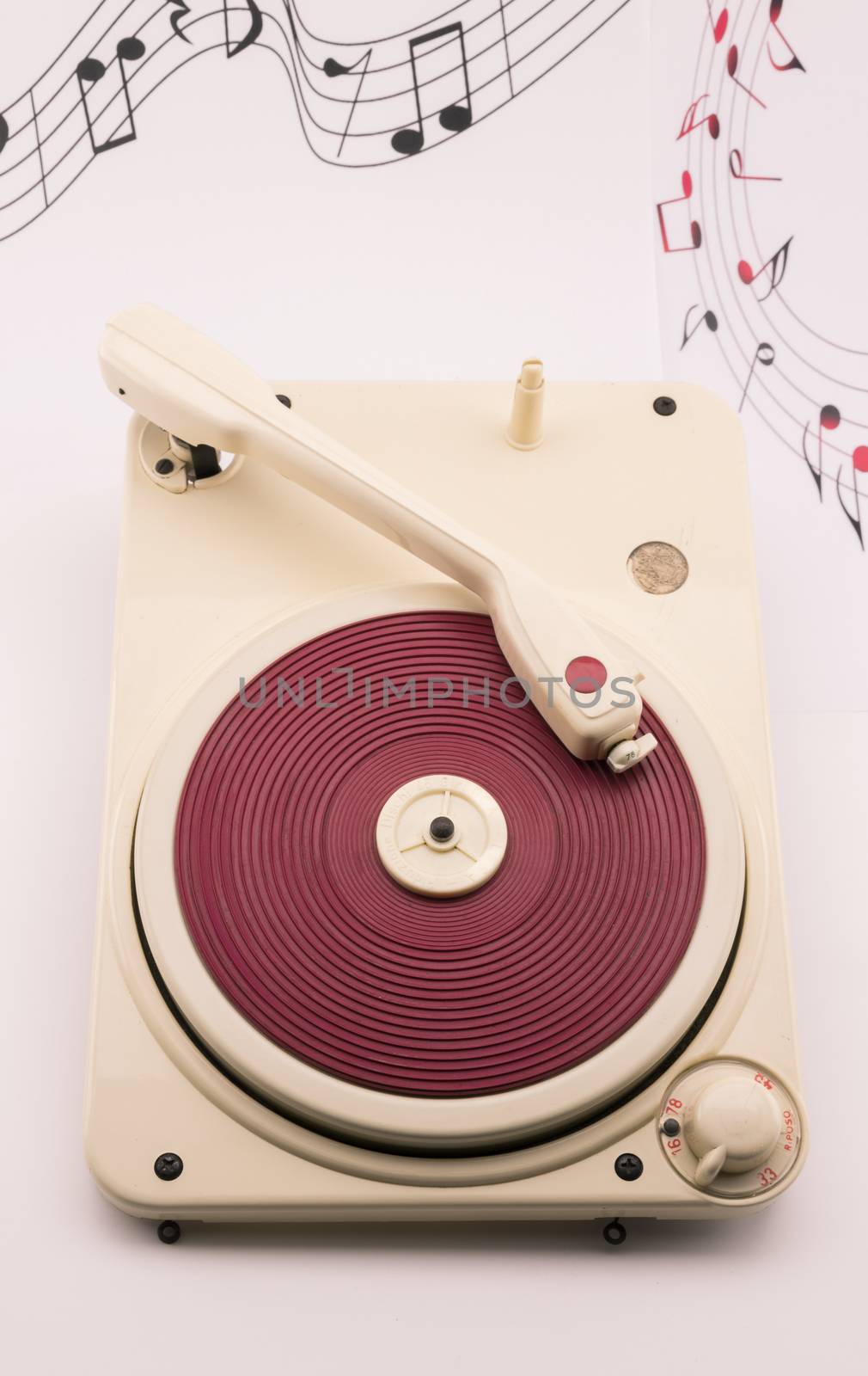 composition with vintage red record player and musical notes on background