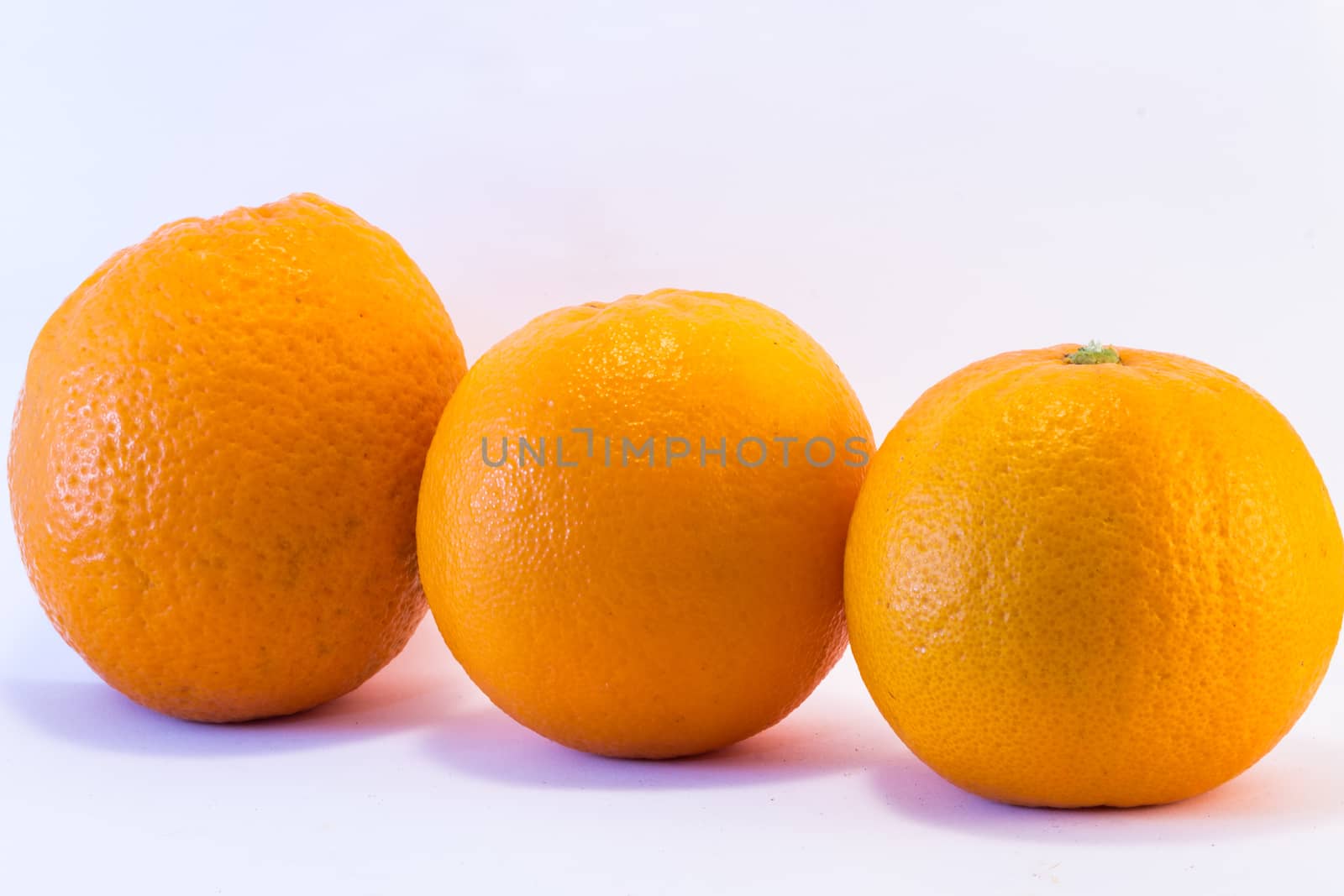 Trio oranges on white background