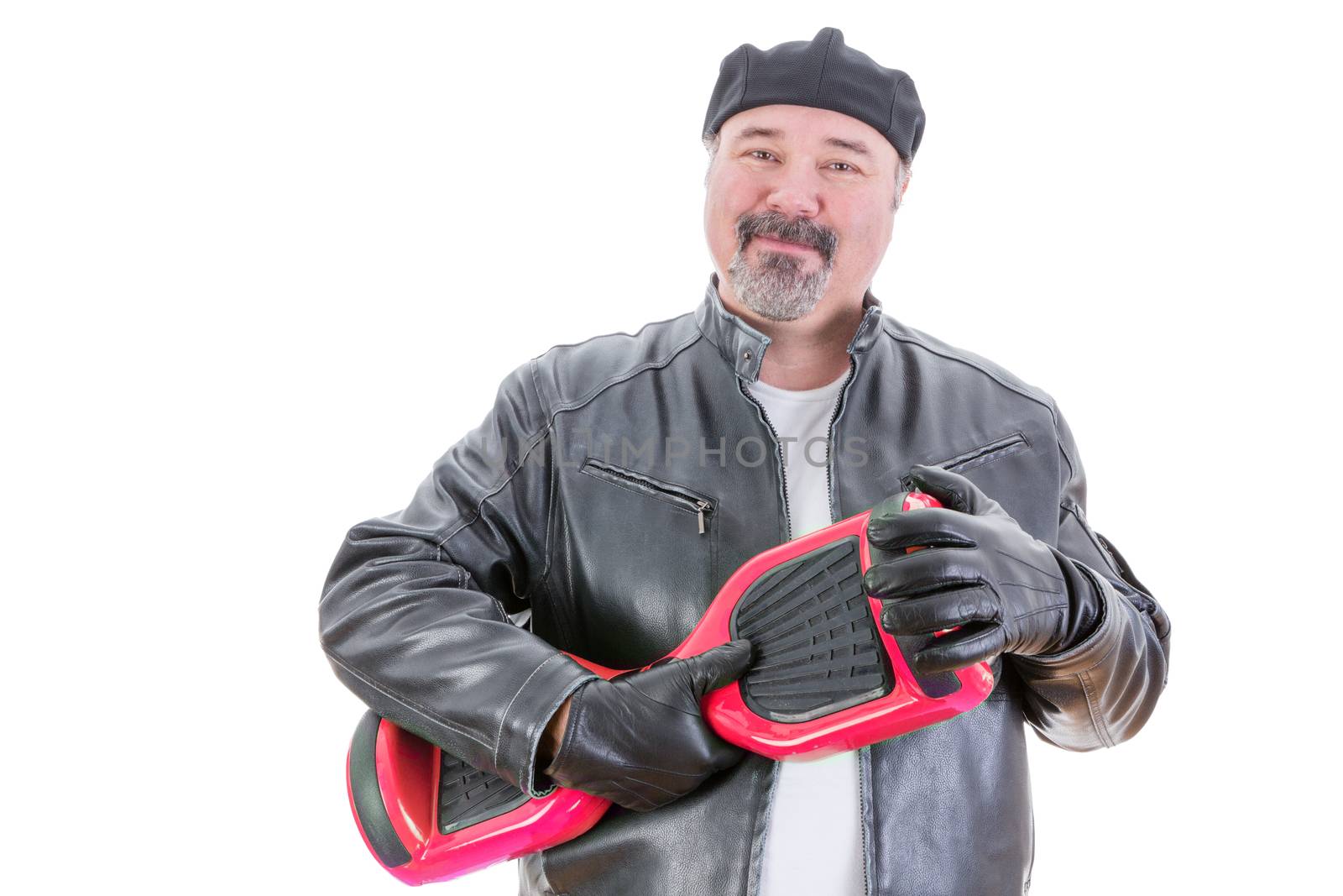 Content middle aged handsome man in hat and leather jacket stands holding a red and black hoverboard in hands with leather gloves