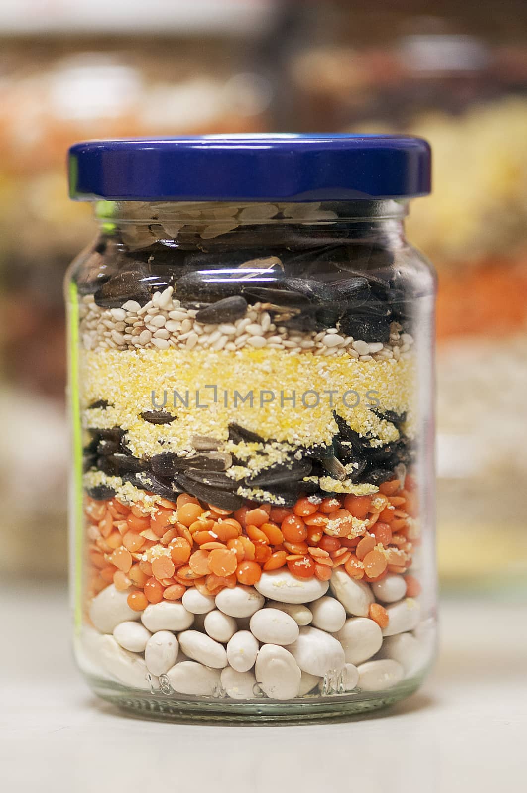 Jar filled with raw seeds. Beans. Sunflower. Lentil