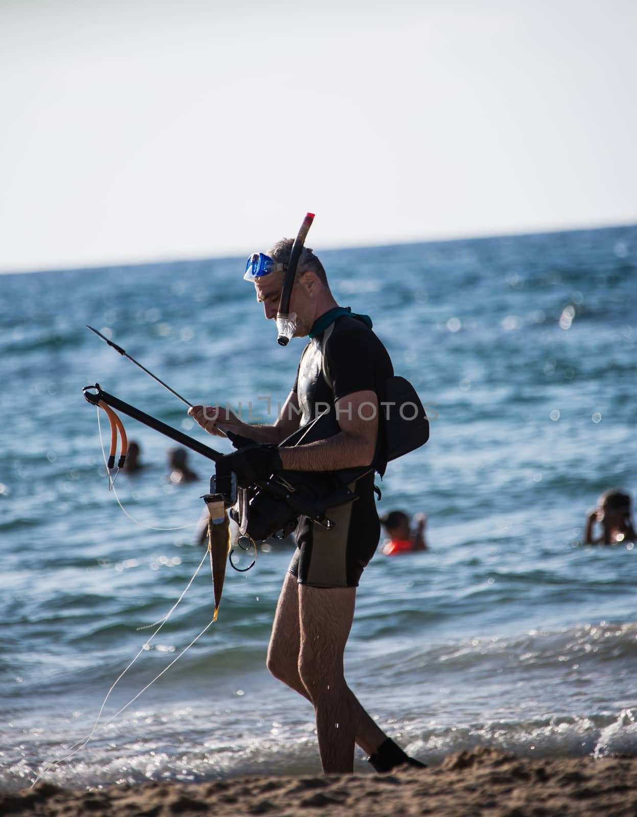 man wearing a mask for diving stands on the shore