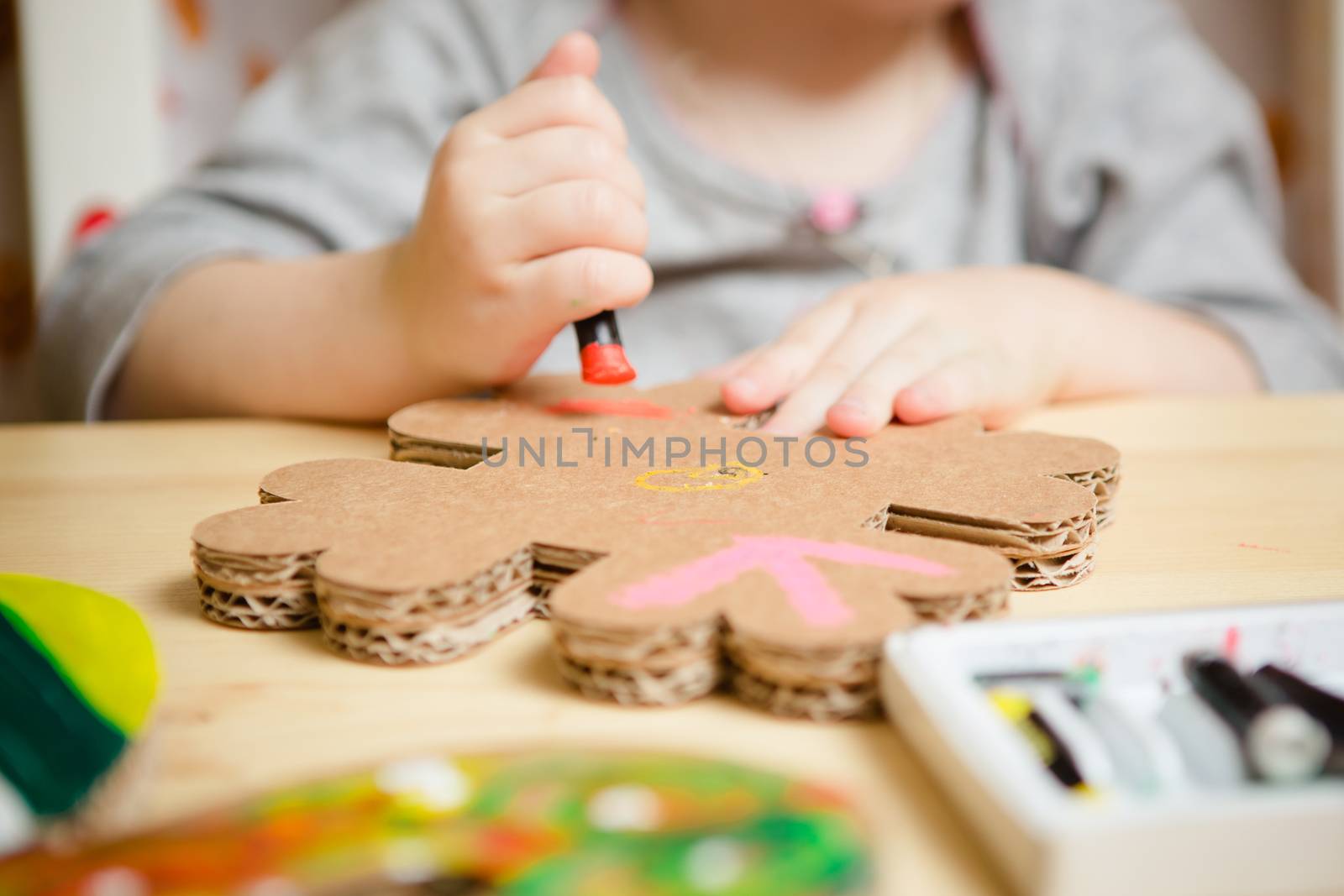 Little female baby painting with colorful paints. selective focus