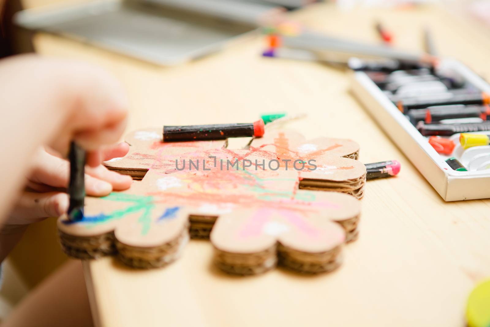 Little female baby painting with colorful paints. selective focus