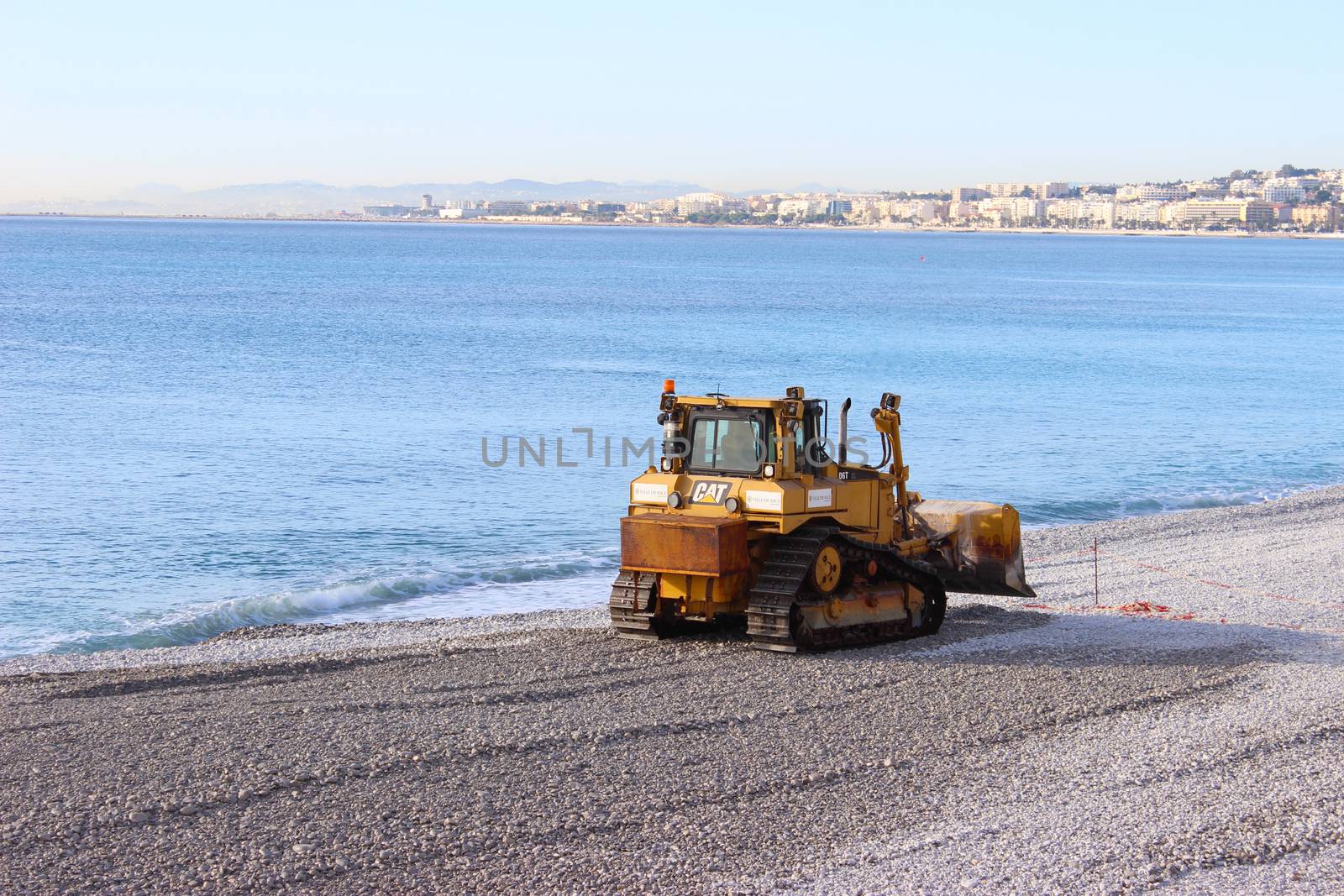 Nice, France - November 30 2015: Bulldozer D6T (Tier 4 Final) Caterpillar working on The Beach of Nice, France