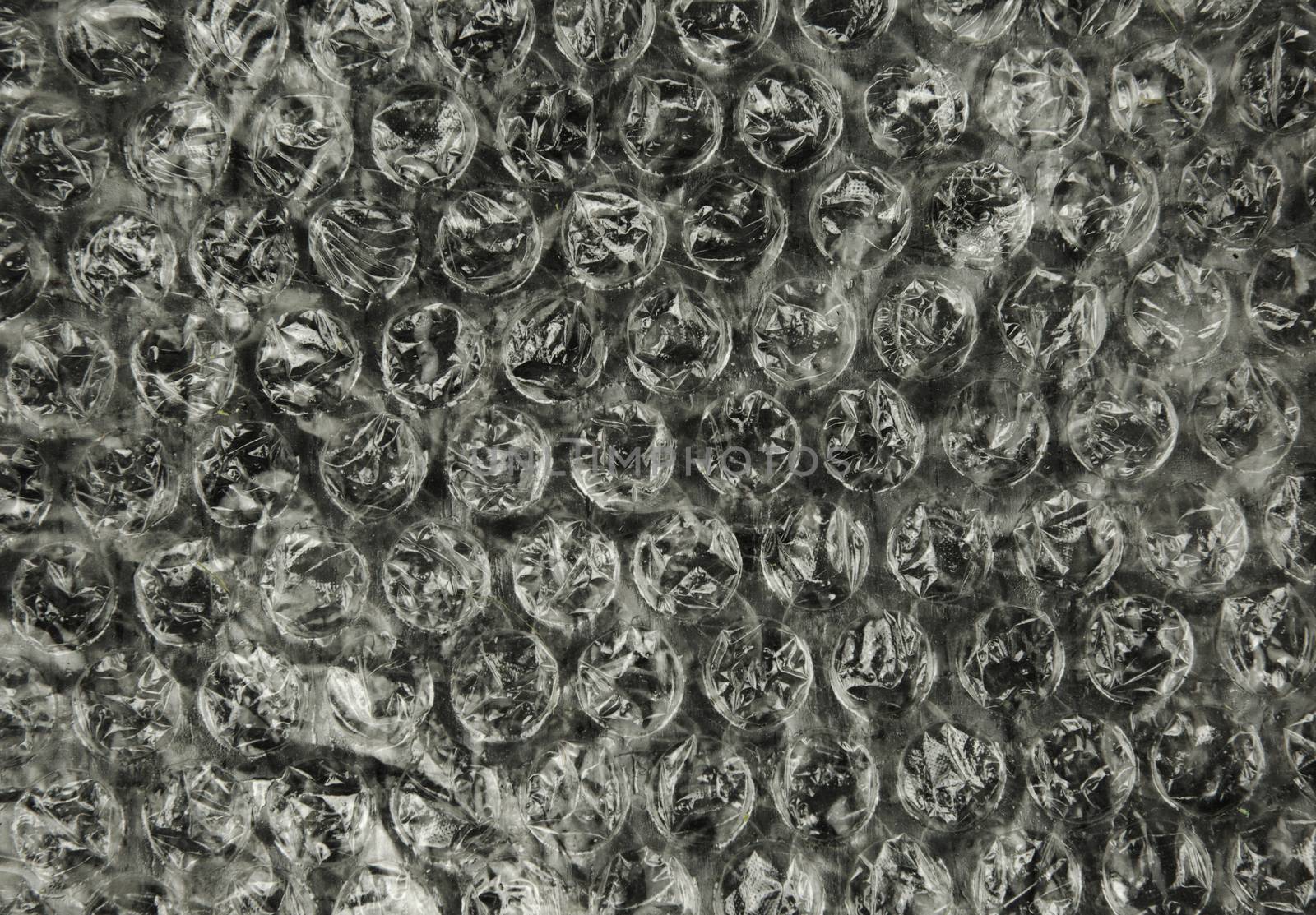 A sheet of bubble foil with clearly visible bubbles and their structure, interesting background and texture. Close , horizontal view.