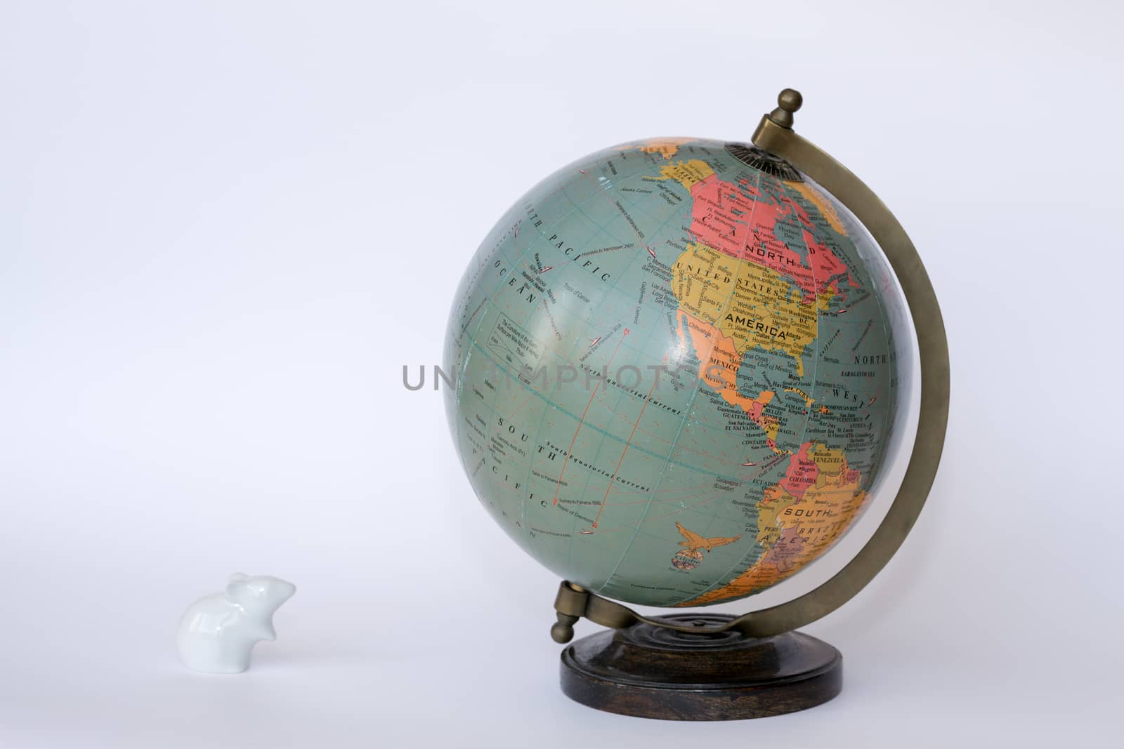 Porcelain mouse staring at a globe