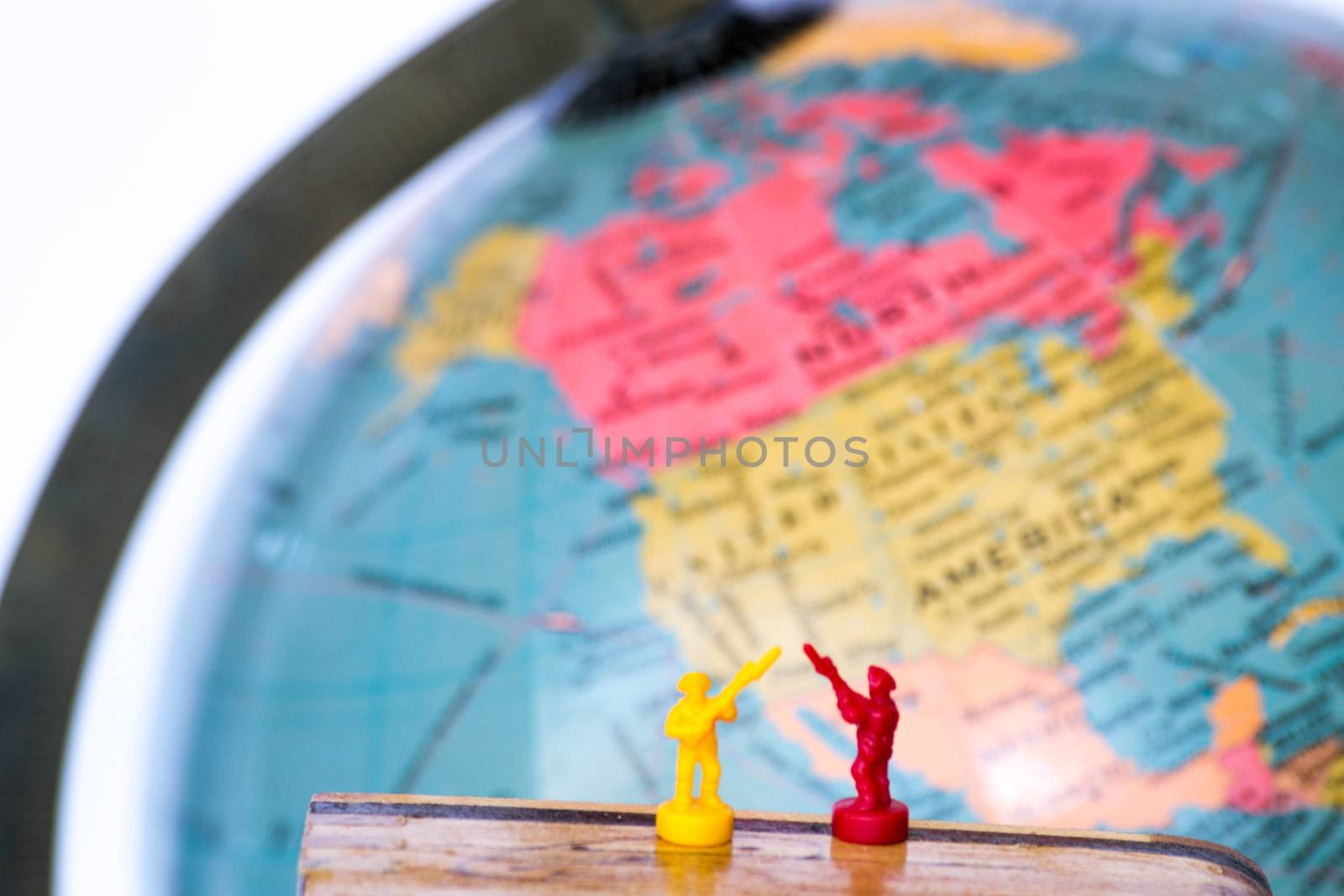 Plastic soldiers in front of a globe