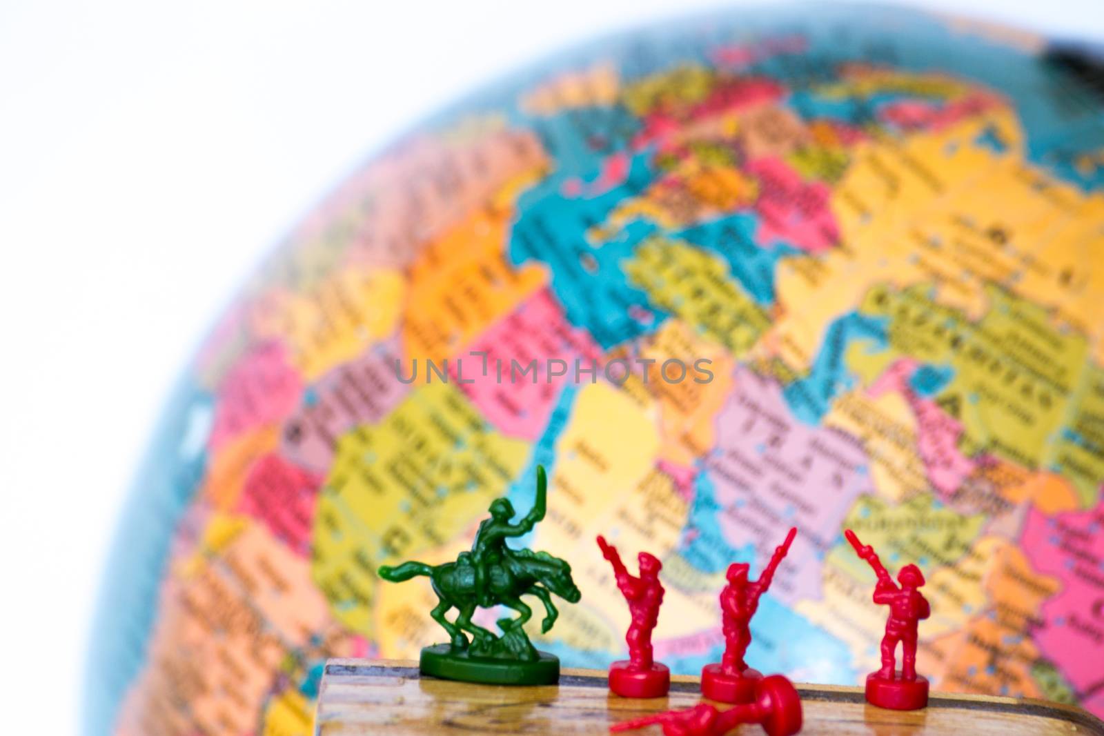 Plastic soldiers in front of a globe