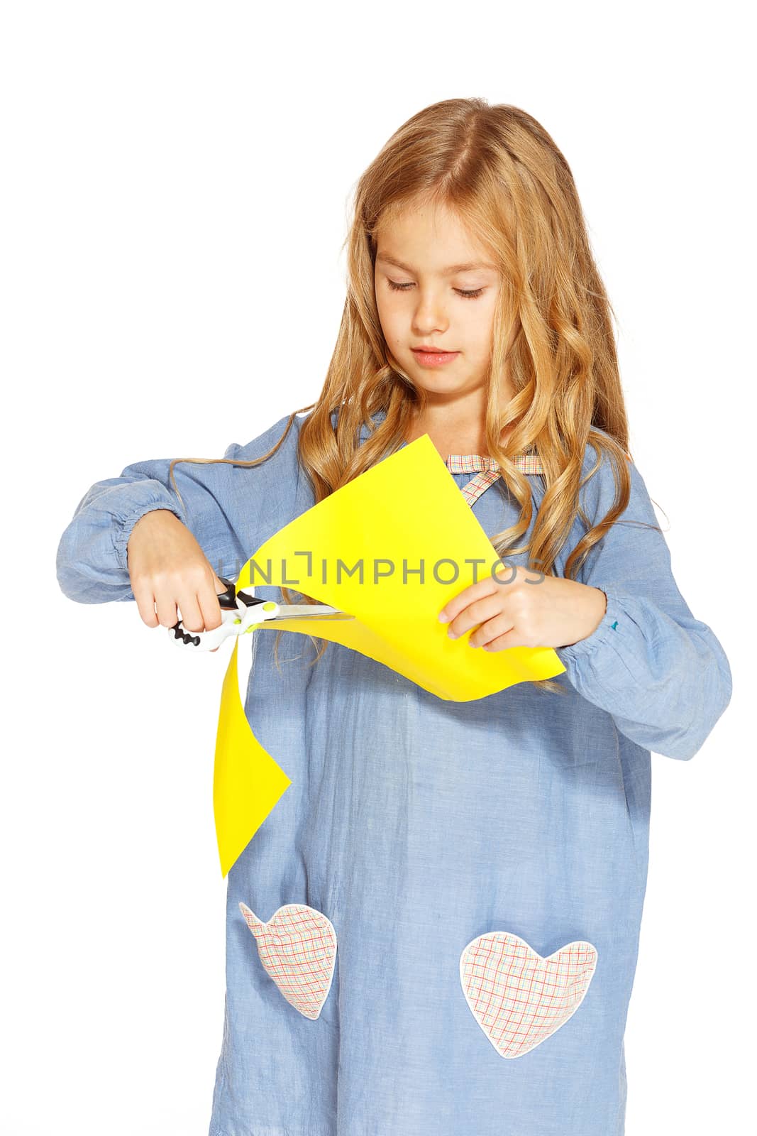 Cute little girl with scissors and yellow paper by gorov108
