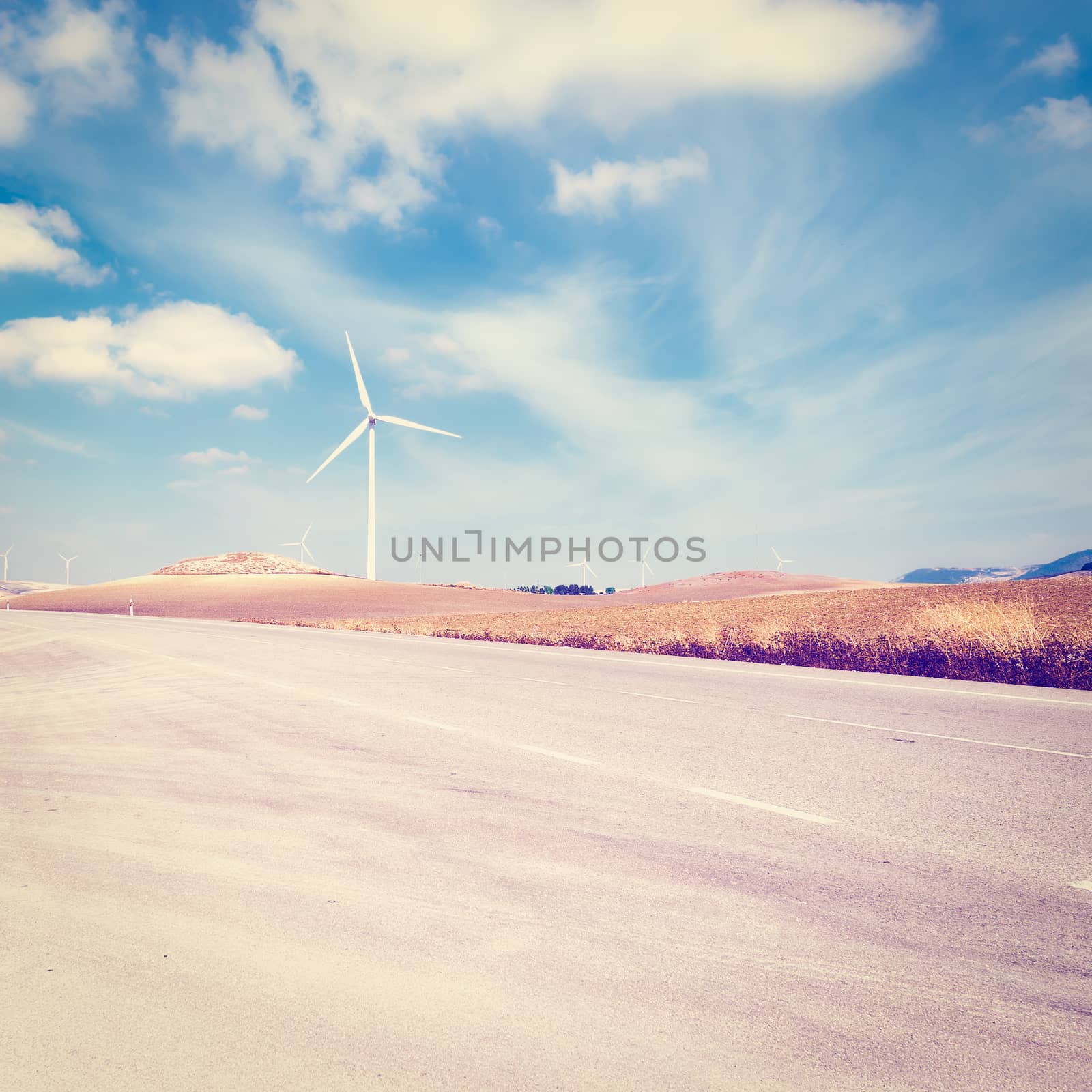 Asphalt Road on the Background of the Modern Wind Turbines Producing Energy in Spain, Instagram Effect
