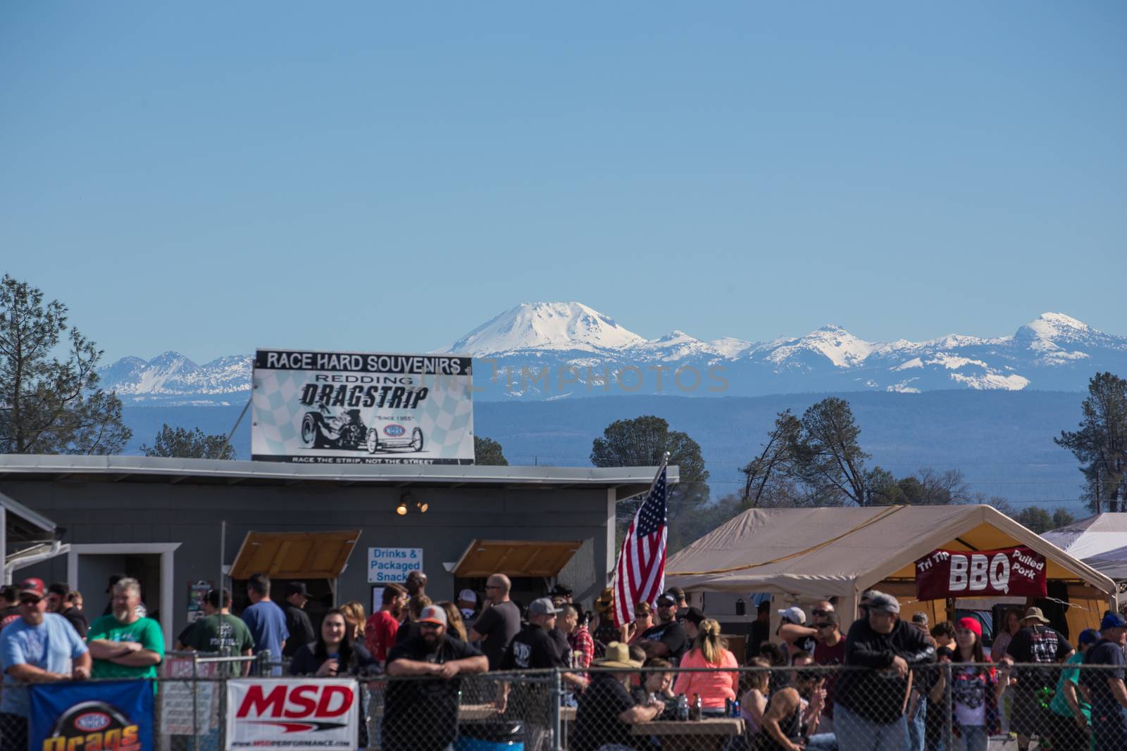 Redding, California: The crowd watches the drag races on a sunny winter day with Mt. Lassen's snow covered peaks in the distance.
Photo taken on: February 13th, 2016
