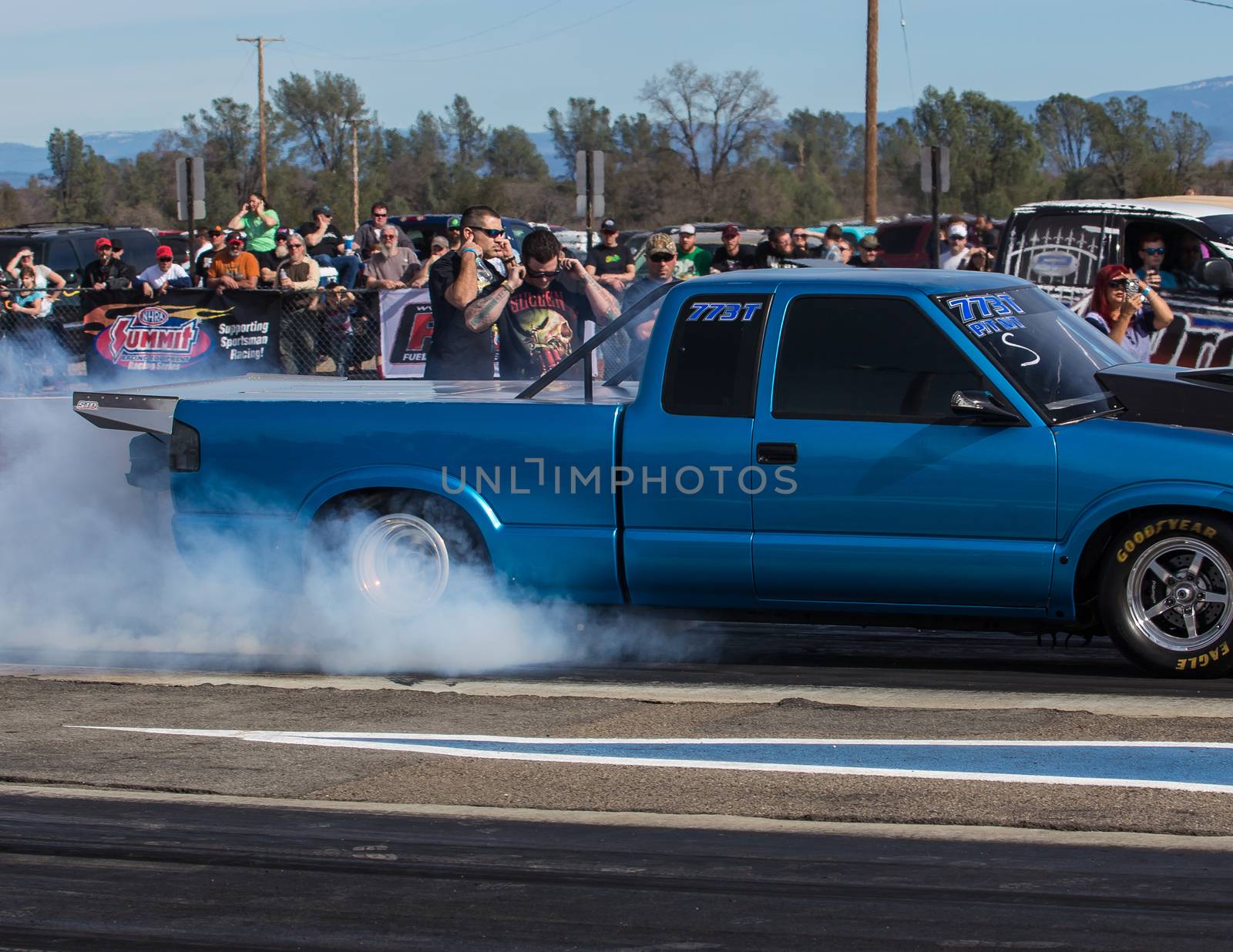 Redding, California: A blue truck burns rubber to get better friction for it's tires before a drag race.
Photo taken on: February 13th, 2016