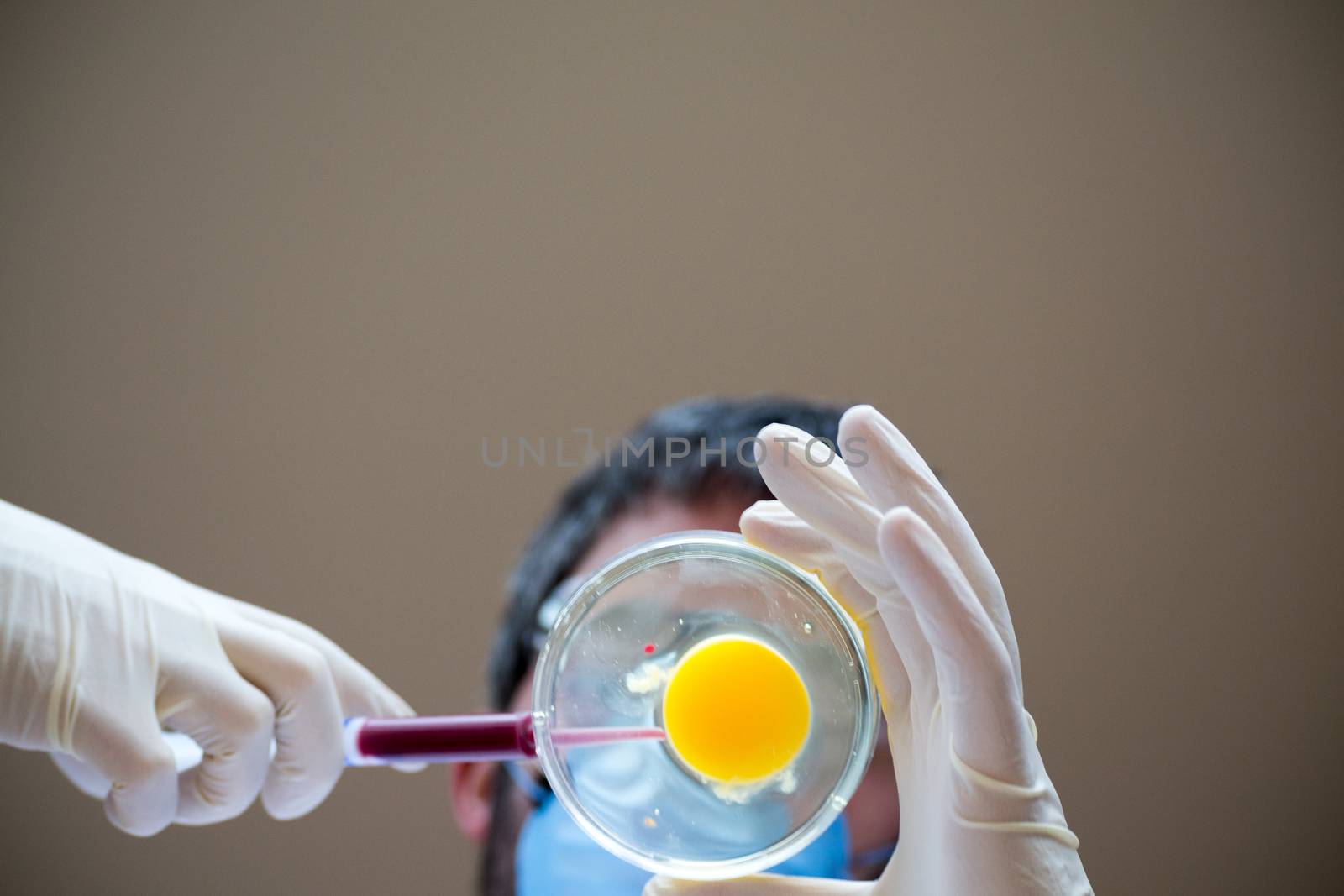 Scientist fertilizing an egg by rmbarricarte