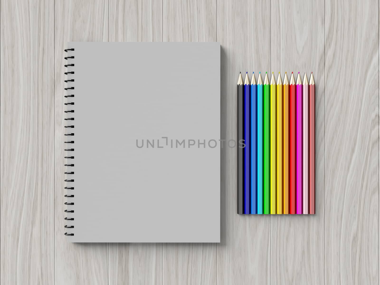 color pencil on checked notebook on wood background by teerawit