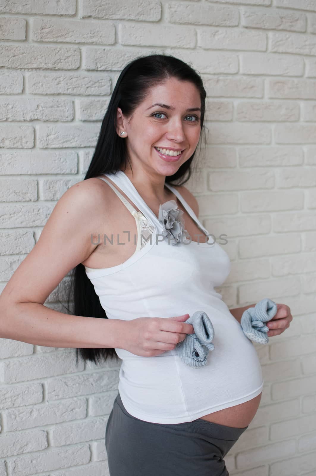 Vertical portrait of the smiling  pregnant woman