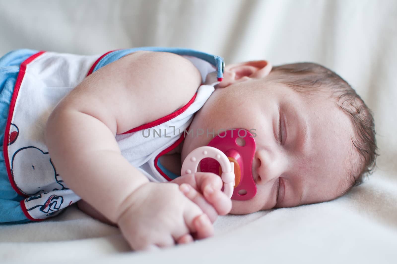 Portrait of the sleeping baby with red nipple