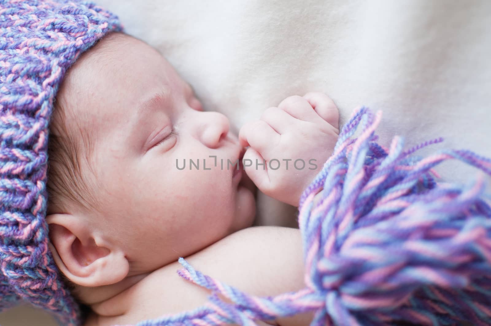 Sleeping baby in purple hat top view portrait by Linaga