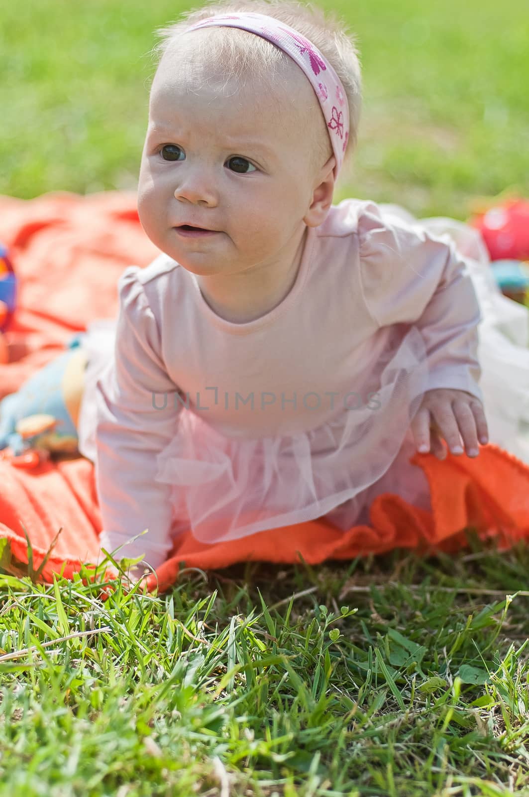 Portrait of the Little girl on the orange towel