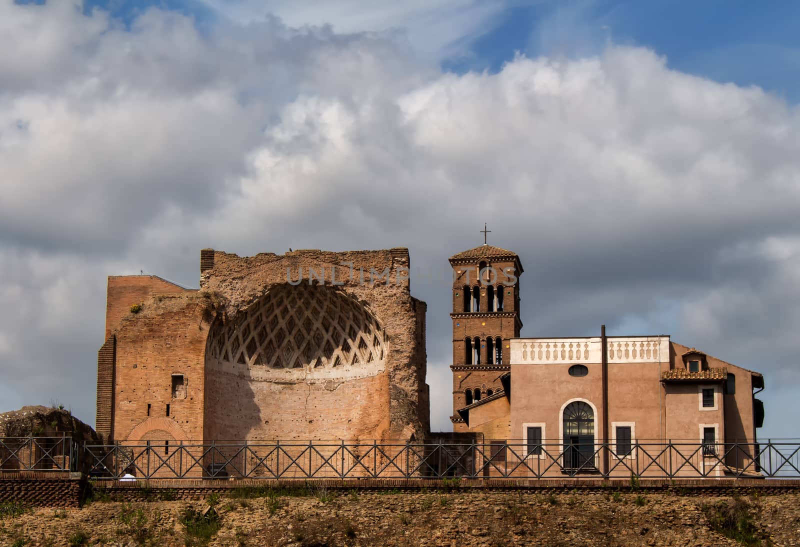 Ancient roman architecture with a very cloudy sky in the background.