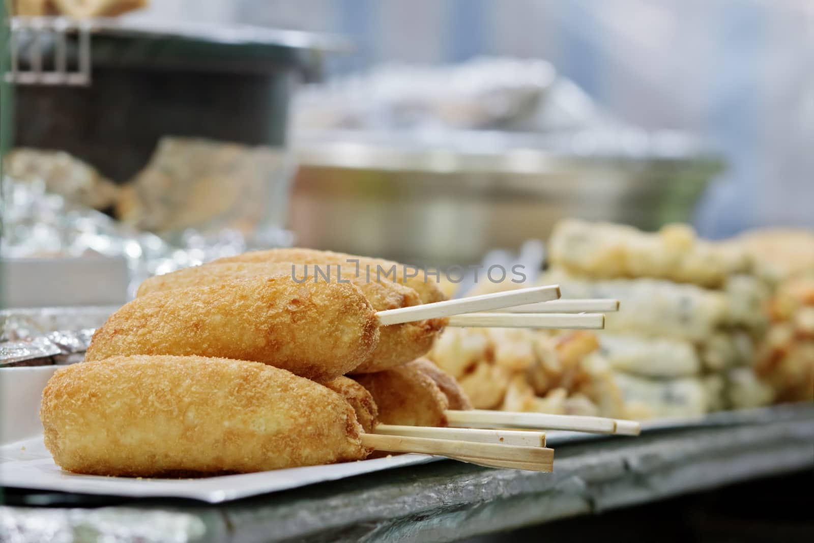 Korean street food: hot dogs wrapped in French fries (gamja dogs) with selected focus