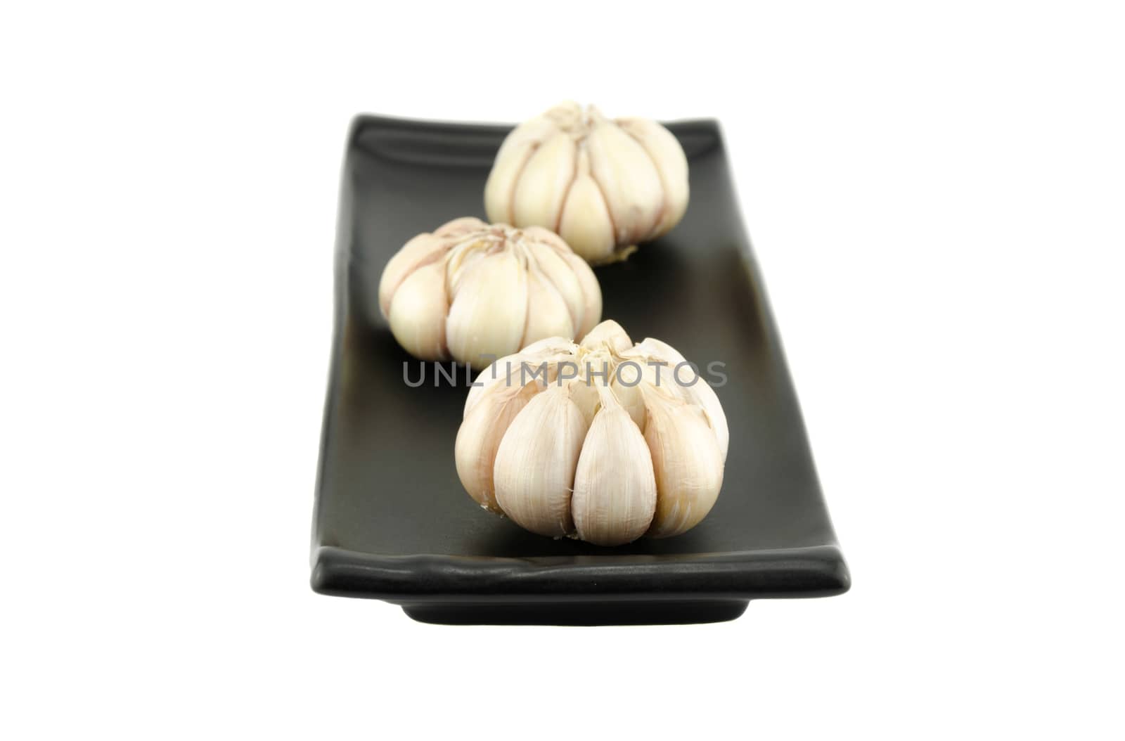 Garlic in the dish and on white background.