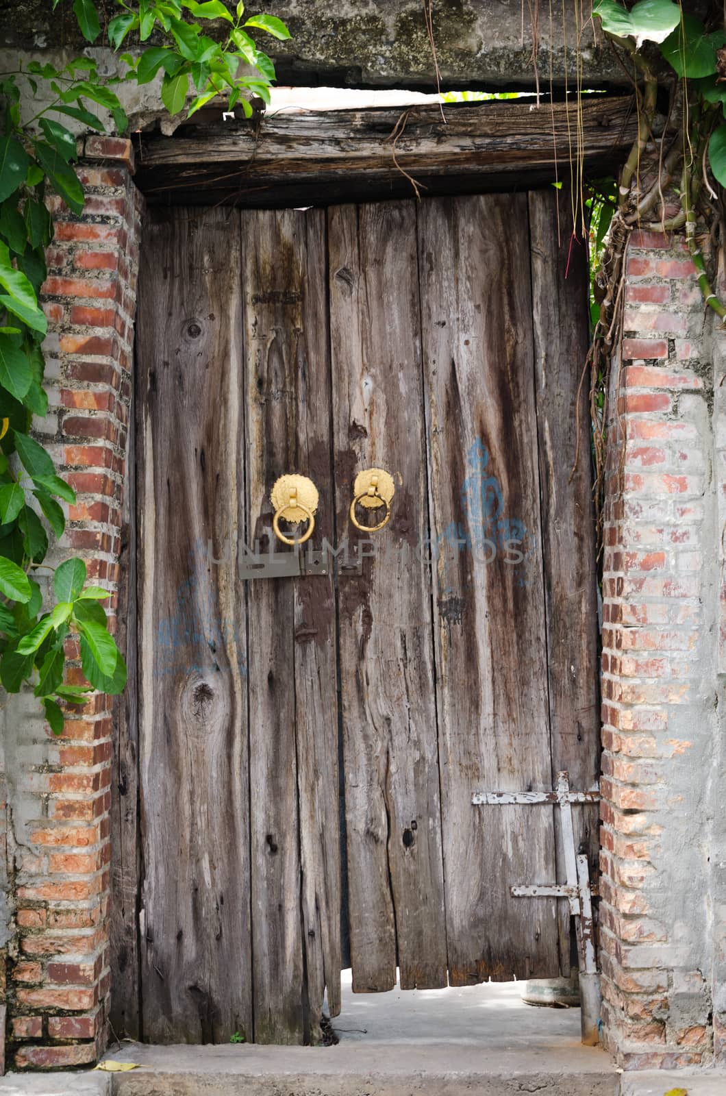 Ancient wooden gate with the inclination and decay.