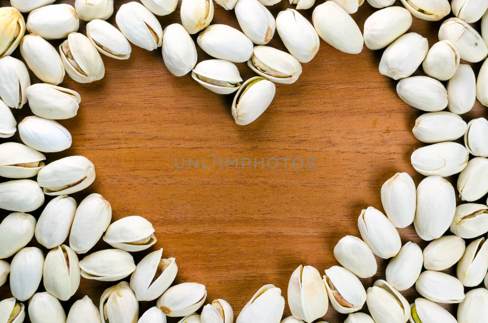 Heart shaped frame made of  pistachio nut  by nop16