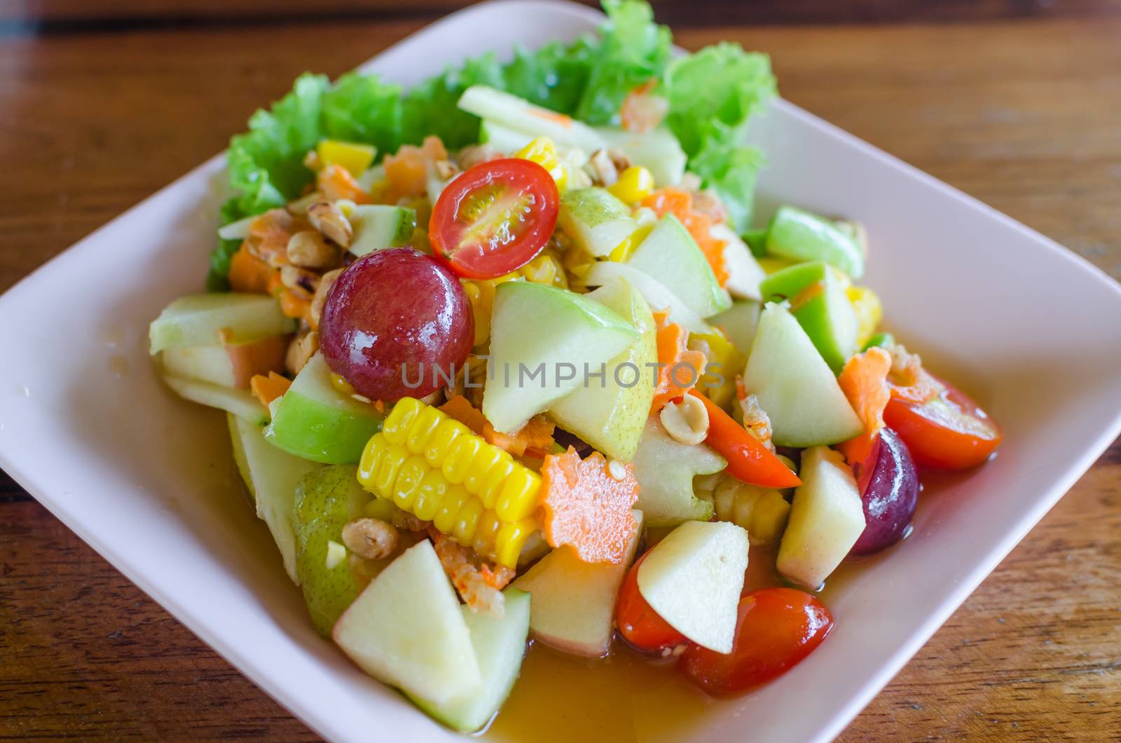 Thailand style fruit salads, mixed fresh fruit with  sauce tastes sour, salty, sweet.