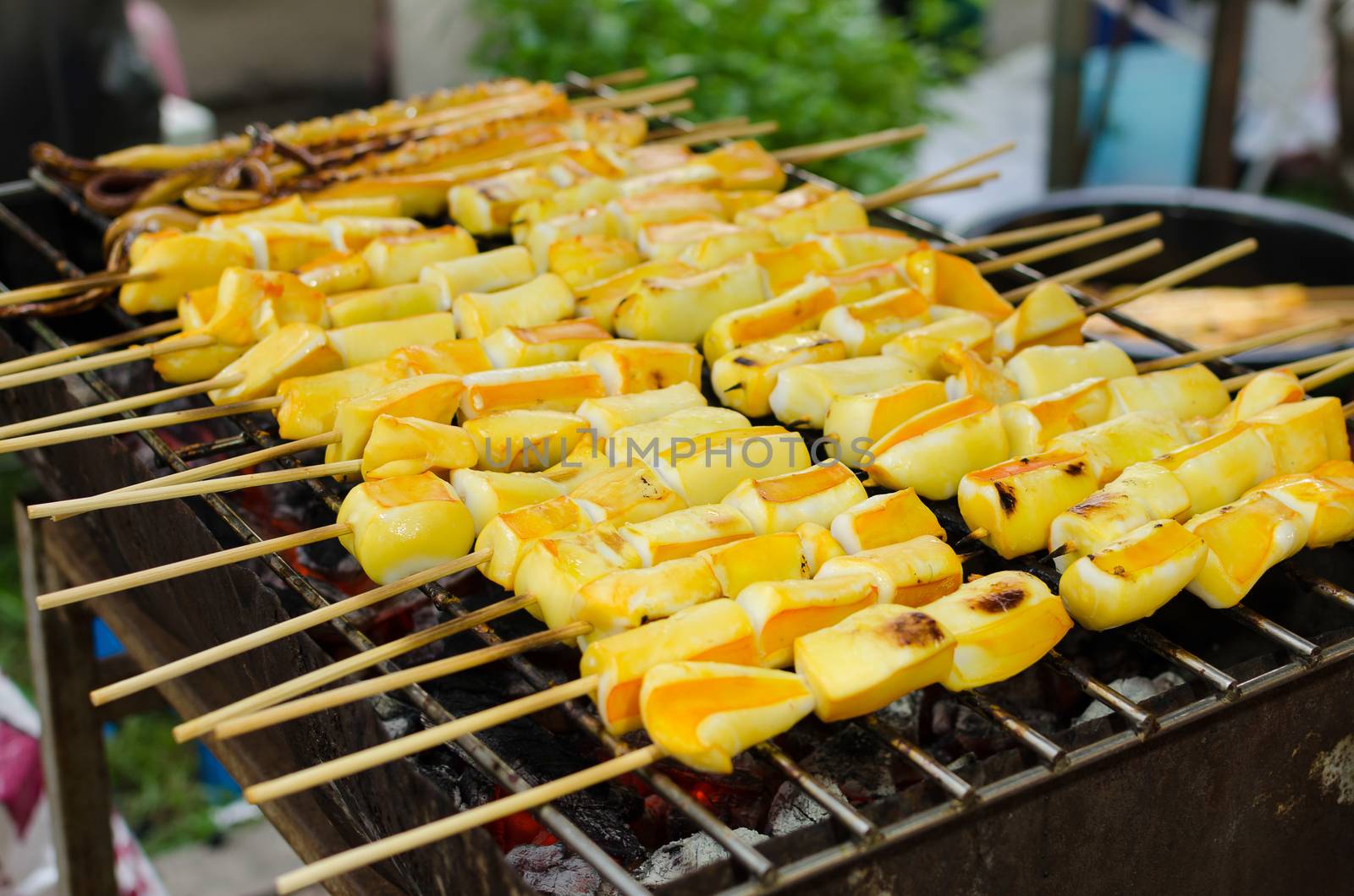 Grilled squid skewers on charcoal Colorful appetizing