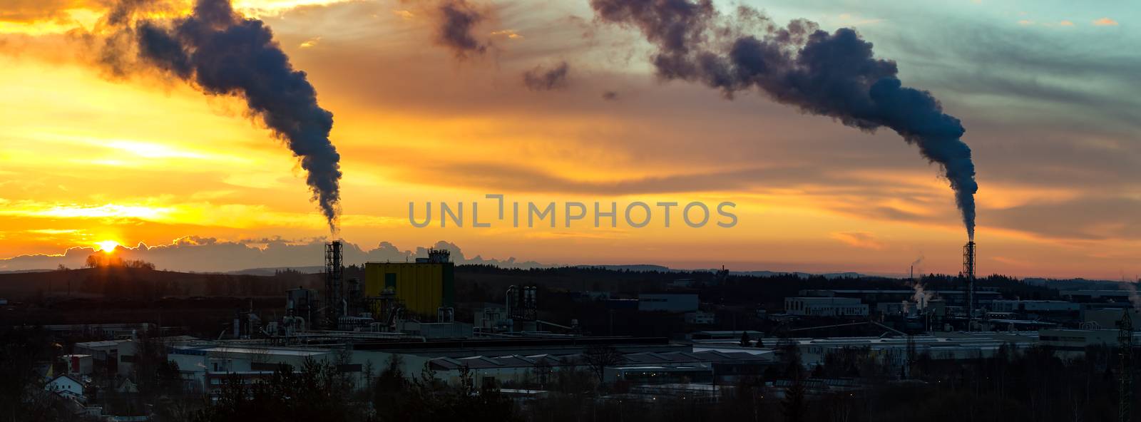 Sunrise silhouette of city landscape with smoking factory, ecology pollution concept