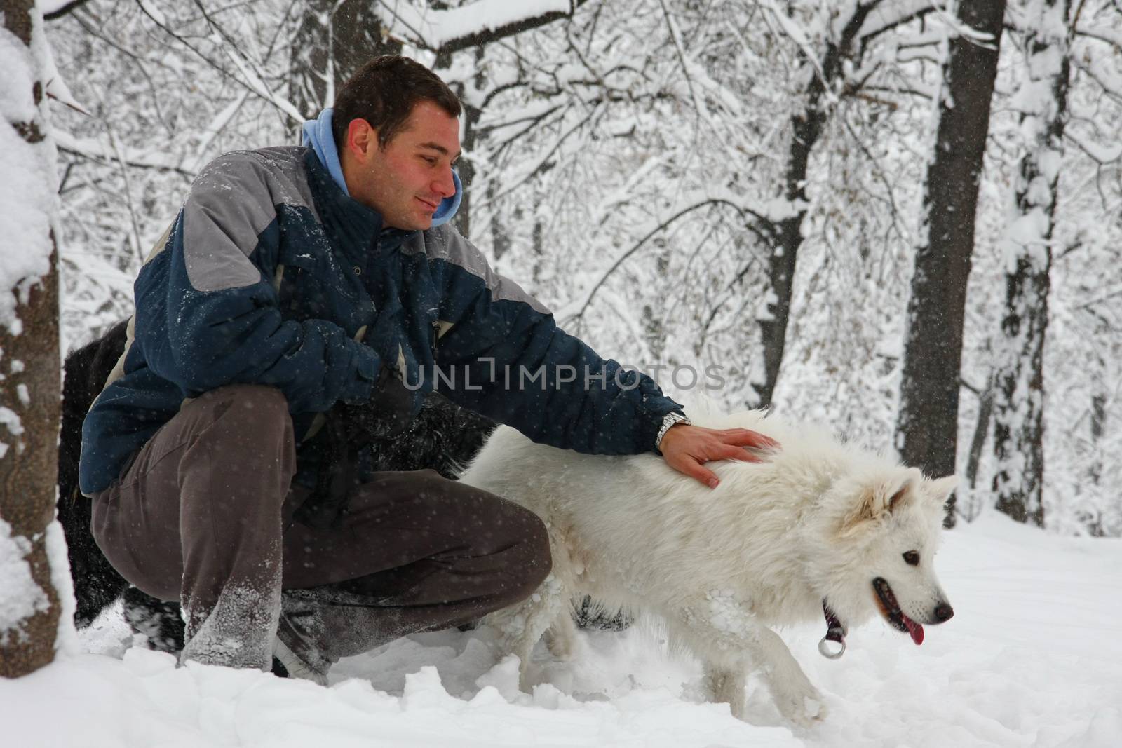 Man and dog in the snow by tdjoric